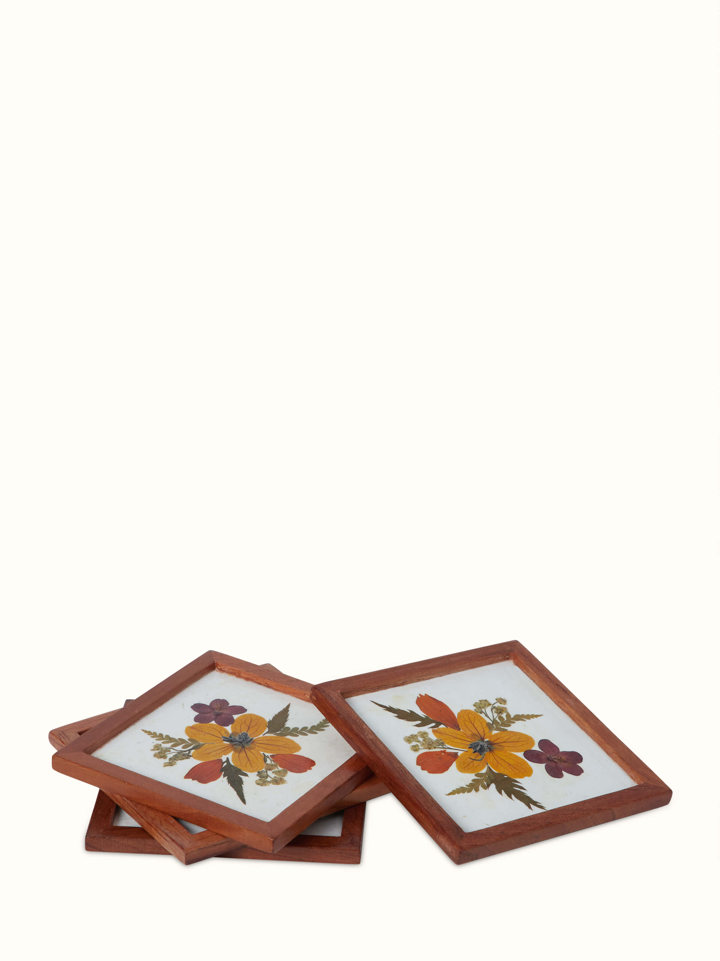 Angled view of Handmade paper floral coasters (4 pcs) showcasing the detailed flower designs and artistic finish