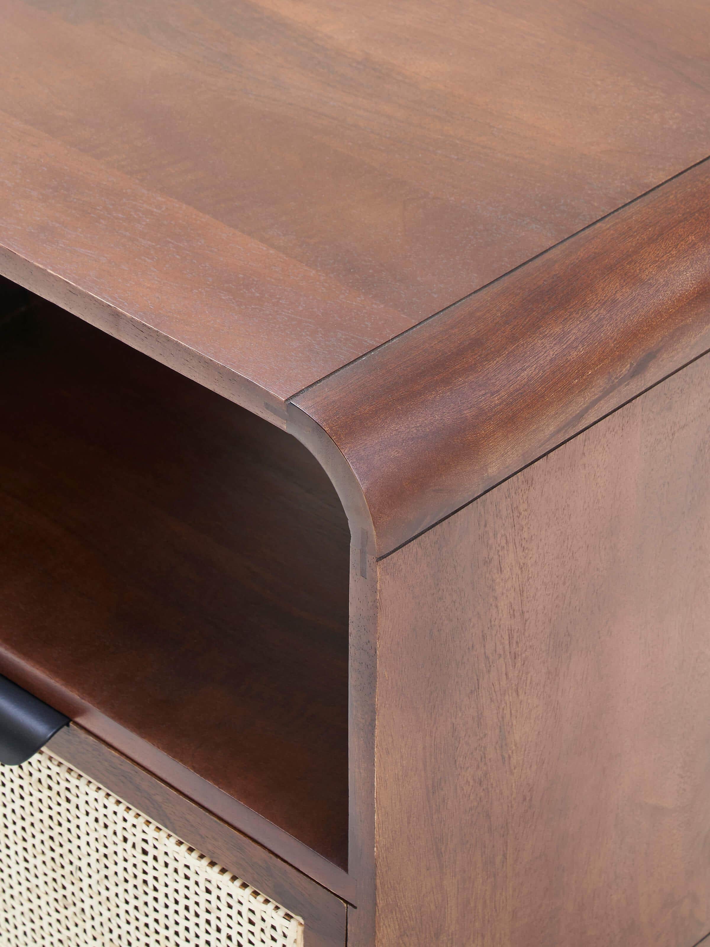 Top view of the mango wood and cane bedside table, focusing on the smooth surface and cane inlay details.