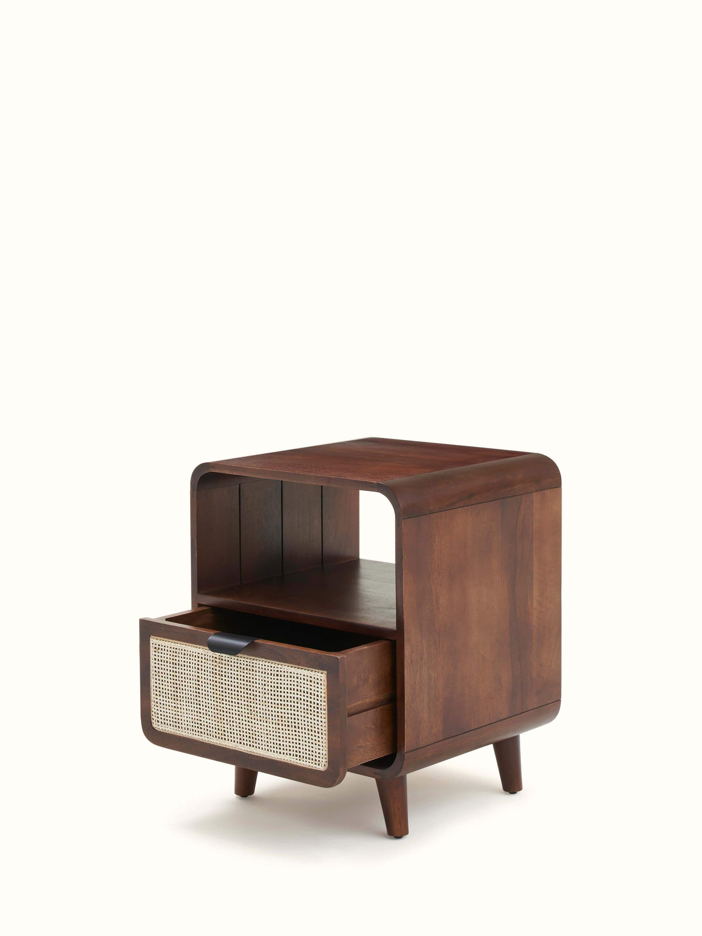 View of the bedside table in a room setting, demonstrating its use as a functional and stylish piece of furniture.