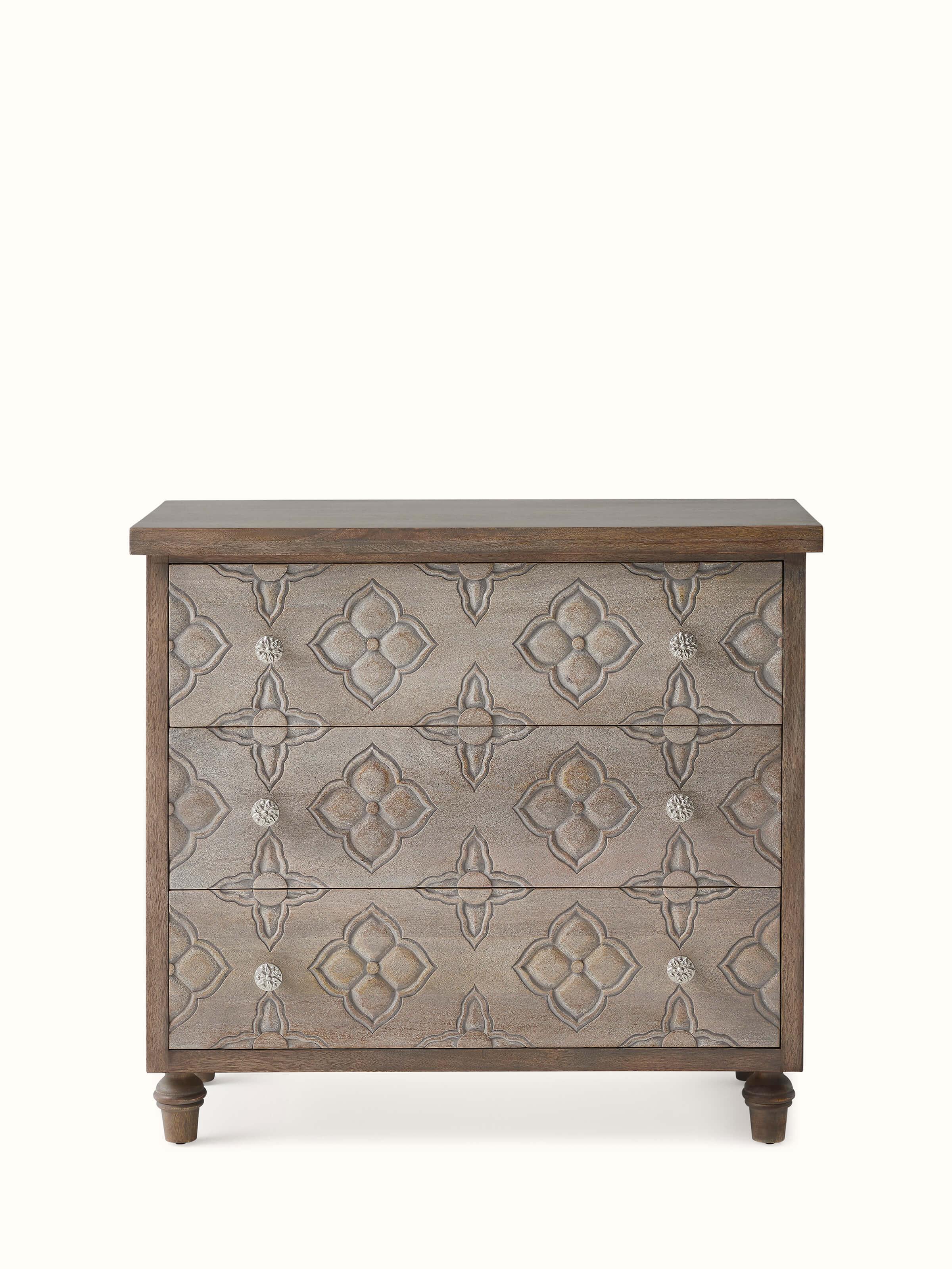 Front view of the carved mango wood chest of drawers, showcasing detailed carvings and elegant design
