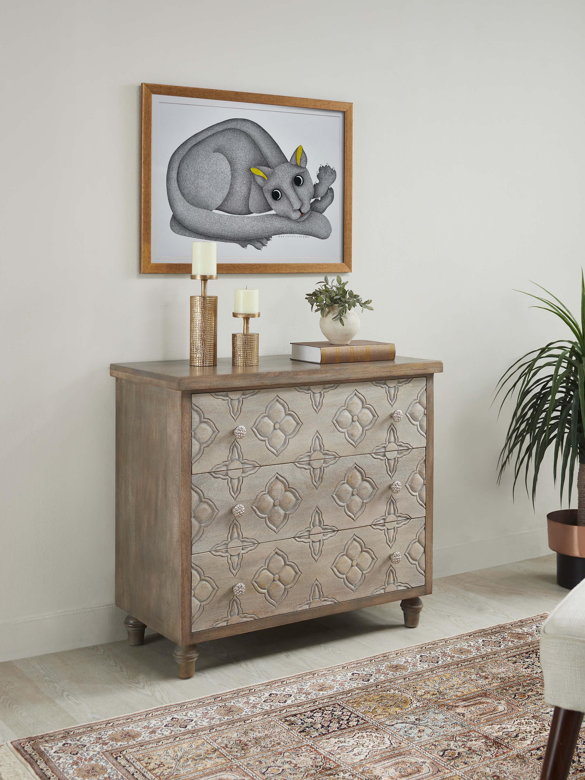 Side view of the mango wood chest of drawers, highlighting the intricate carvings and craftsmanship