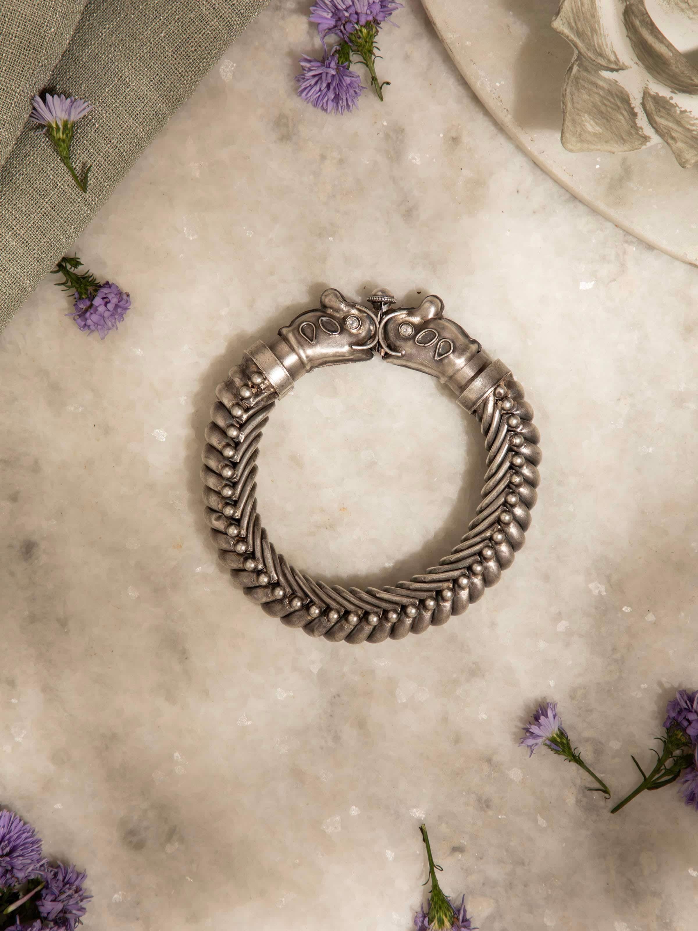 Overhead view of silver smithing bangle revealing its full design and artisanal finish.
