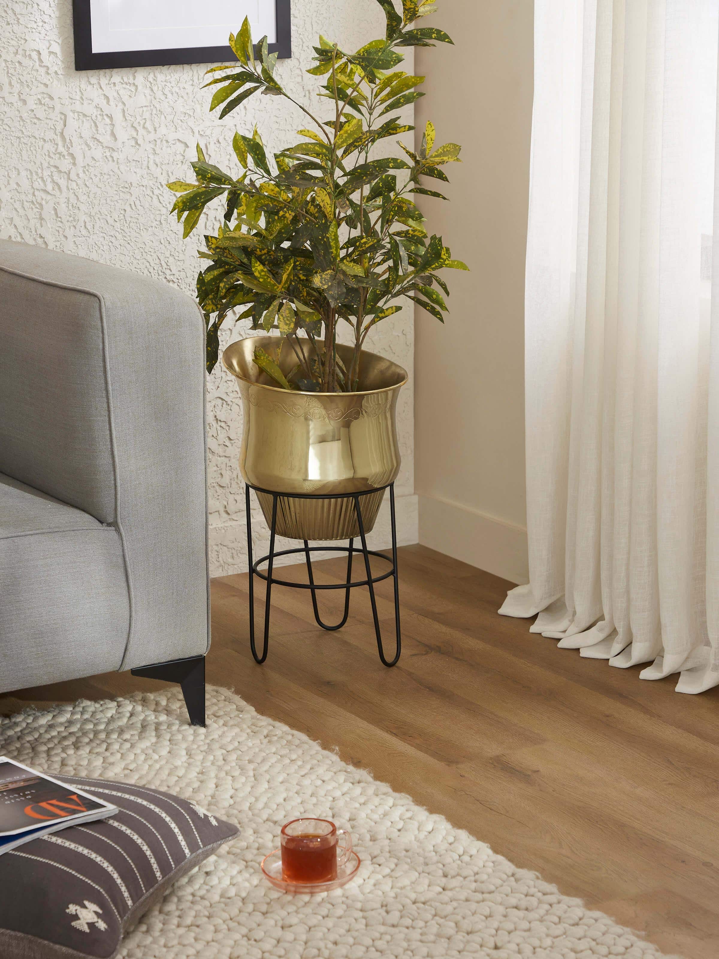 Side view of Glossy Brass Planter, showcasing its elegant design and reflective quality