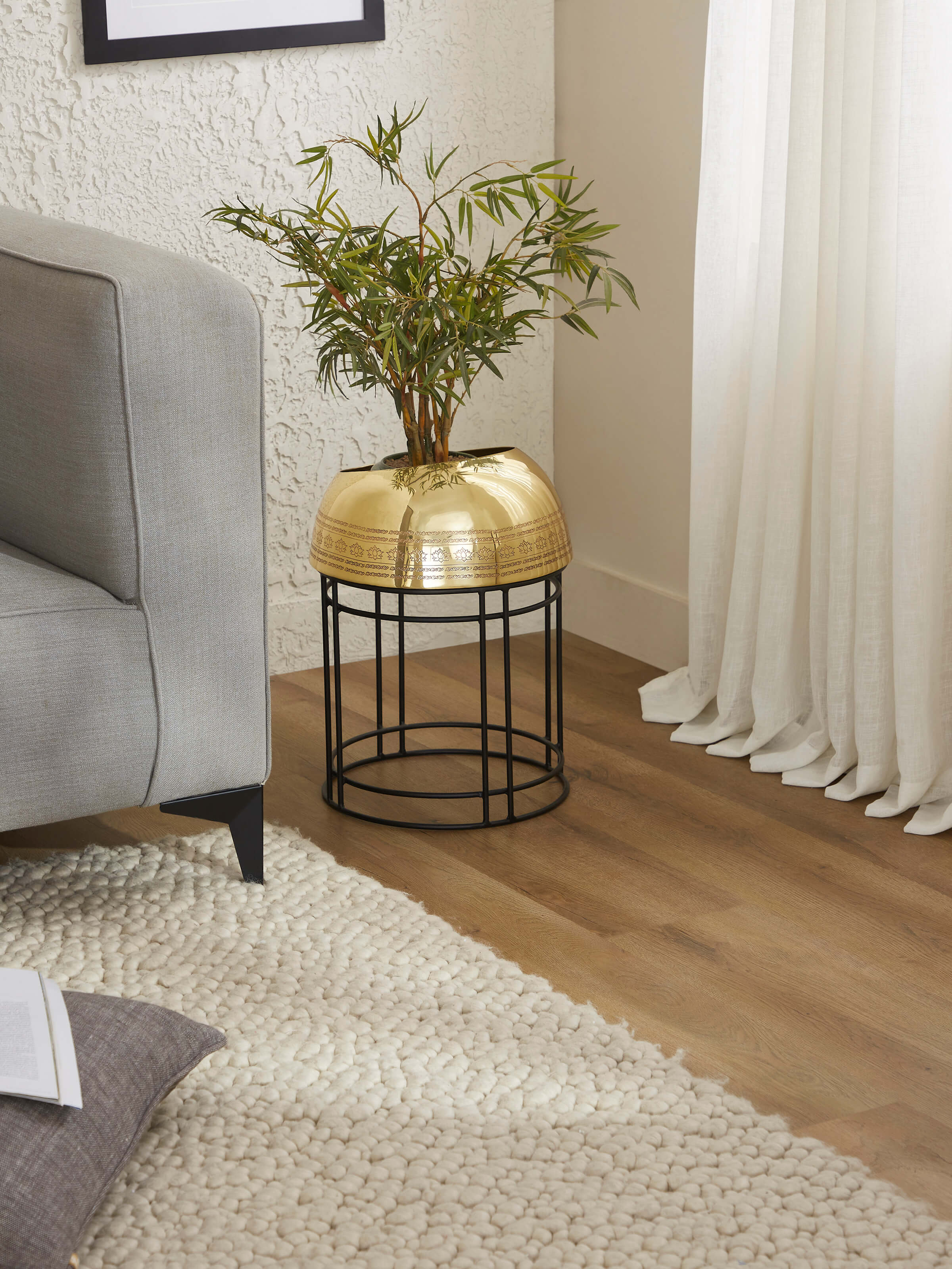 Side view of Brass planter showcasing detailed craftsmanship and stylish curves