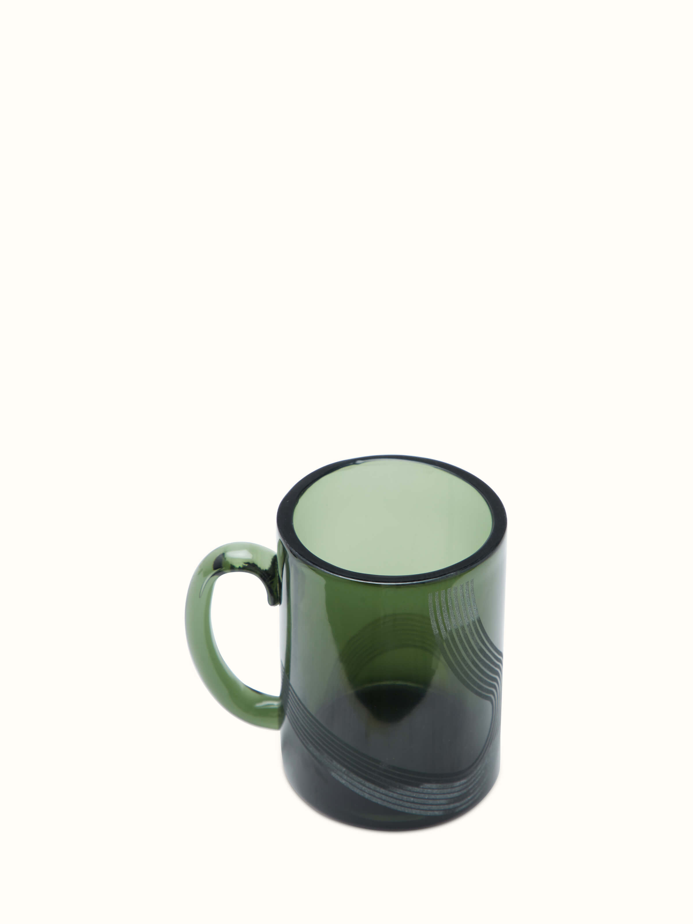 Side view of Firozabadi green glass coffee mugs showing the elegant curves and detailed craftsmanship