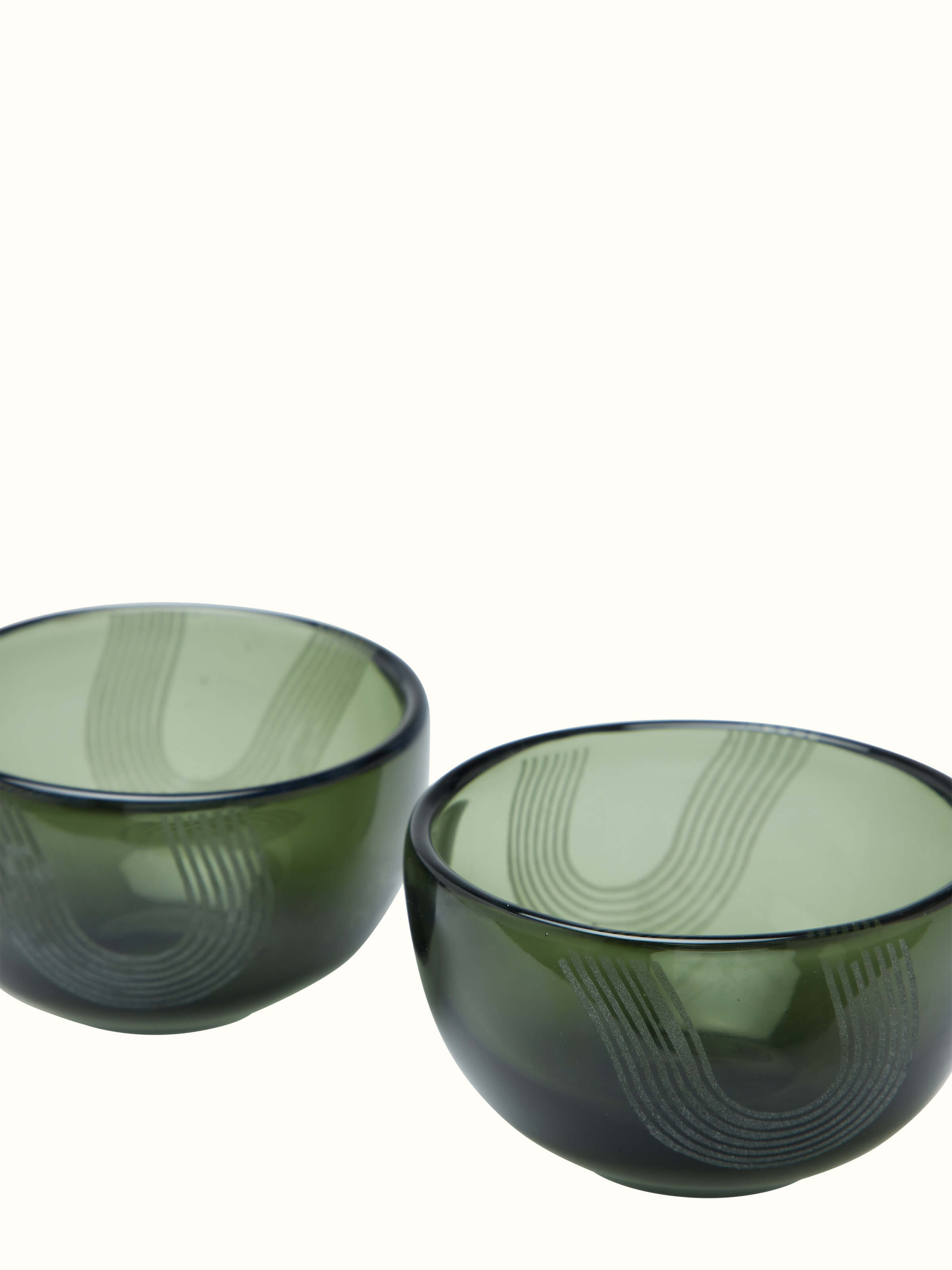 Close-up of Firozabadi glass nut bowls in green, highlighting the fine glass detailing and texture