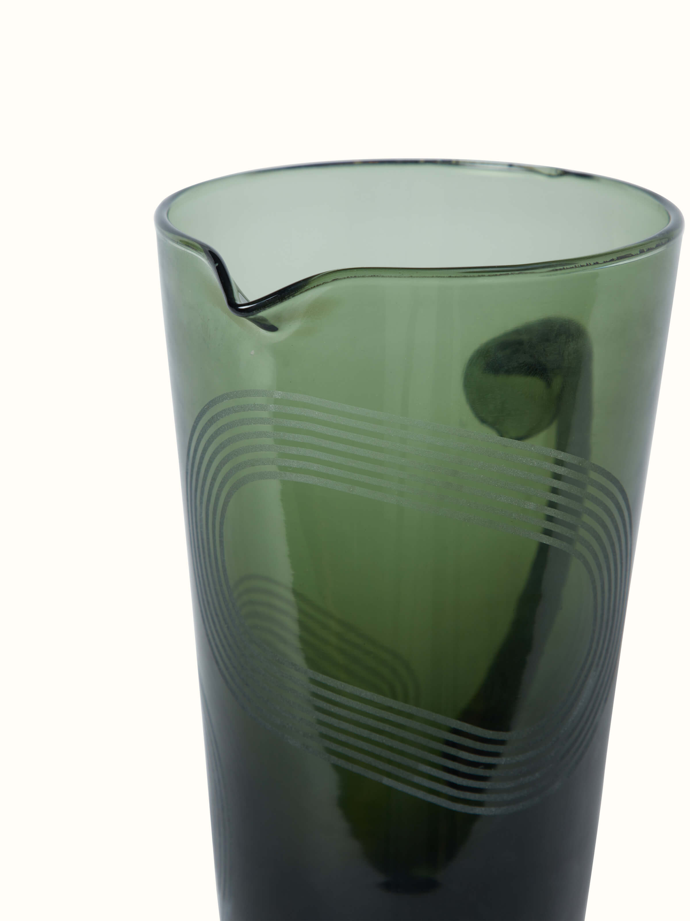 Artistic view of Firozabadi Glass Pitcher in Green, showing the pitcher from a unique angle