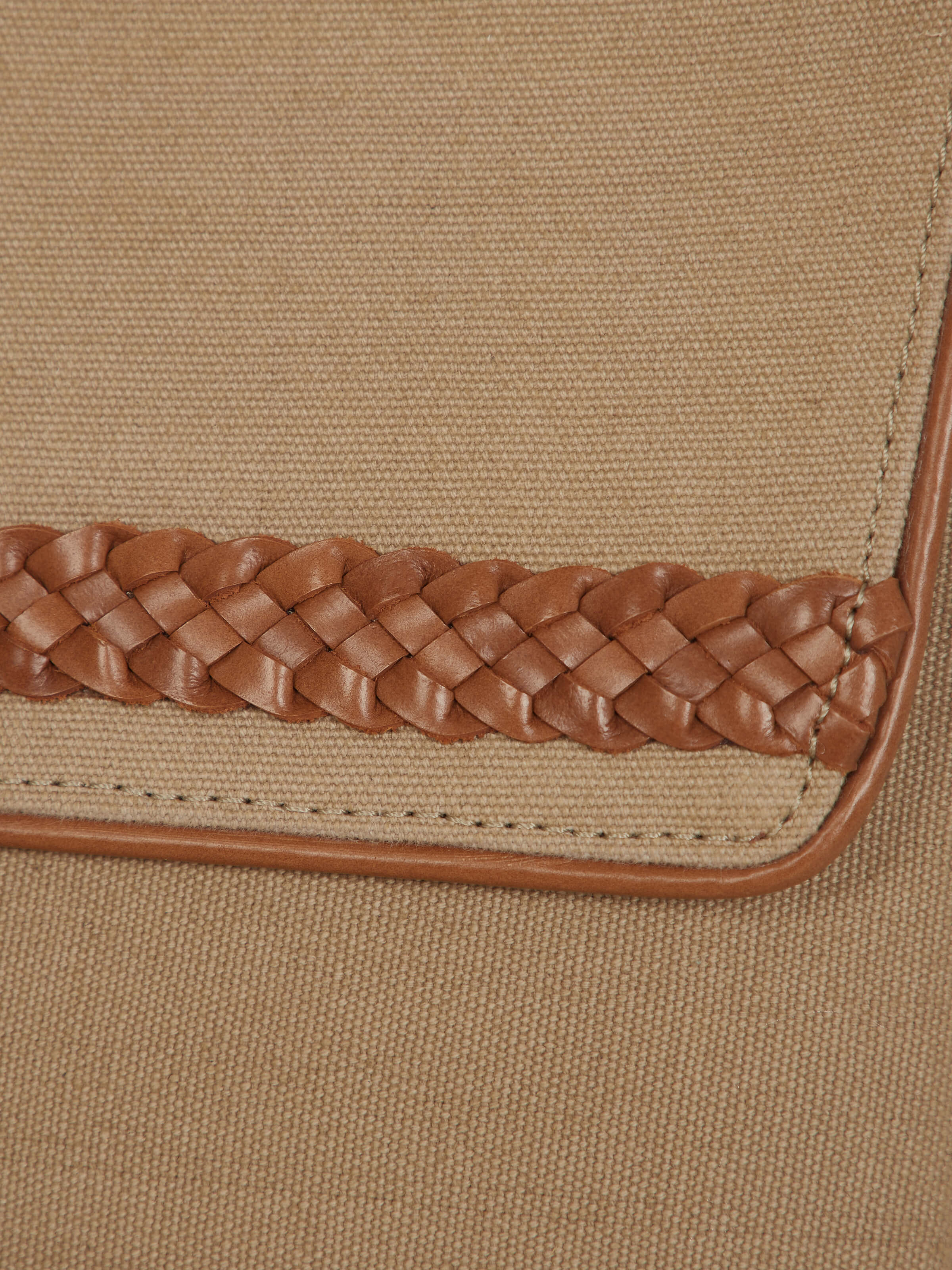 Angled view of Leather laptop bag for MacBook 16 emphasizing the spacious compartments and stylish design