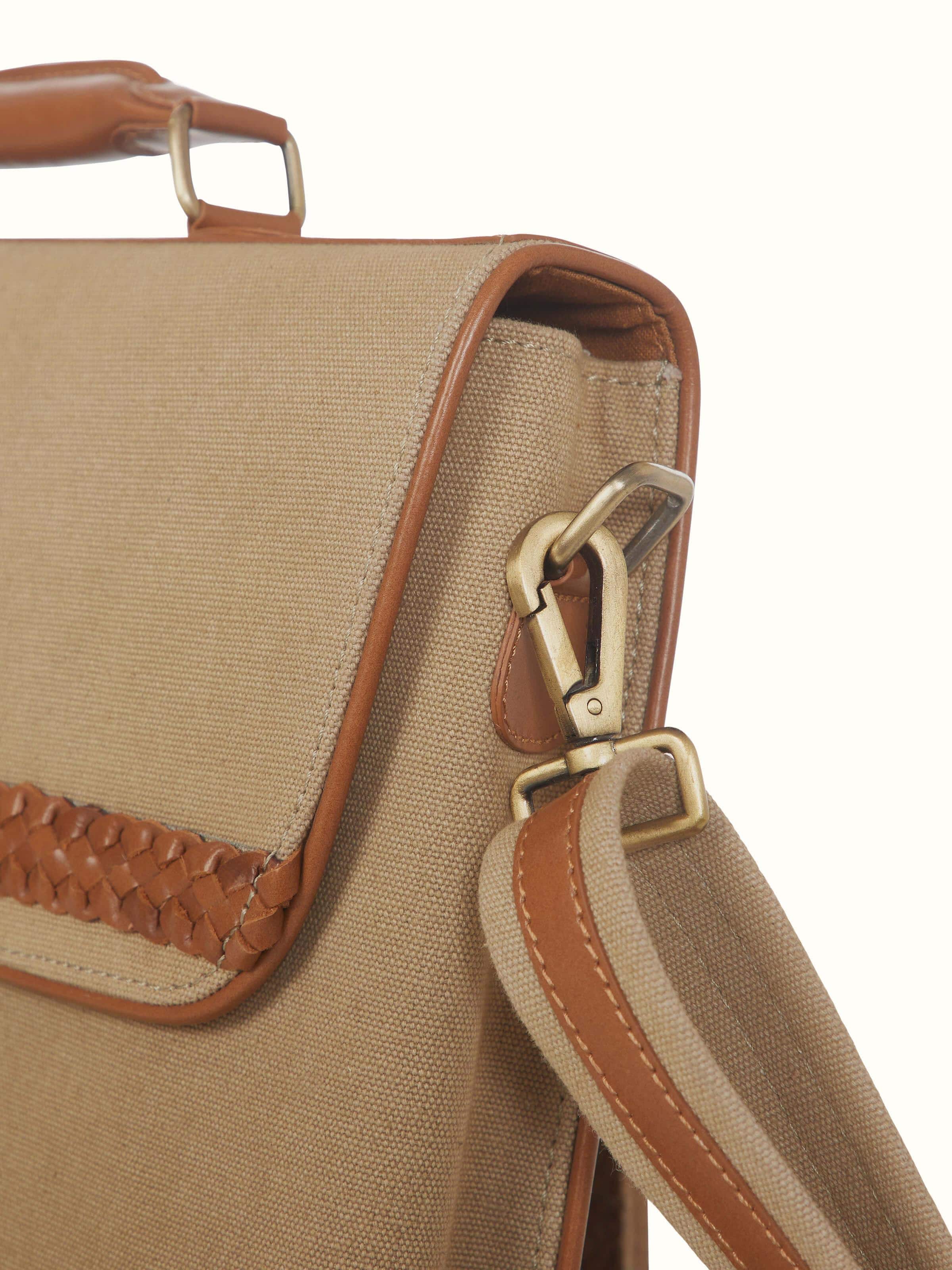Close-up view of Leather laptop bag focusing on the detailed stitching and leather grain.