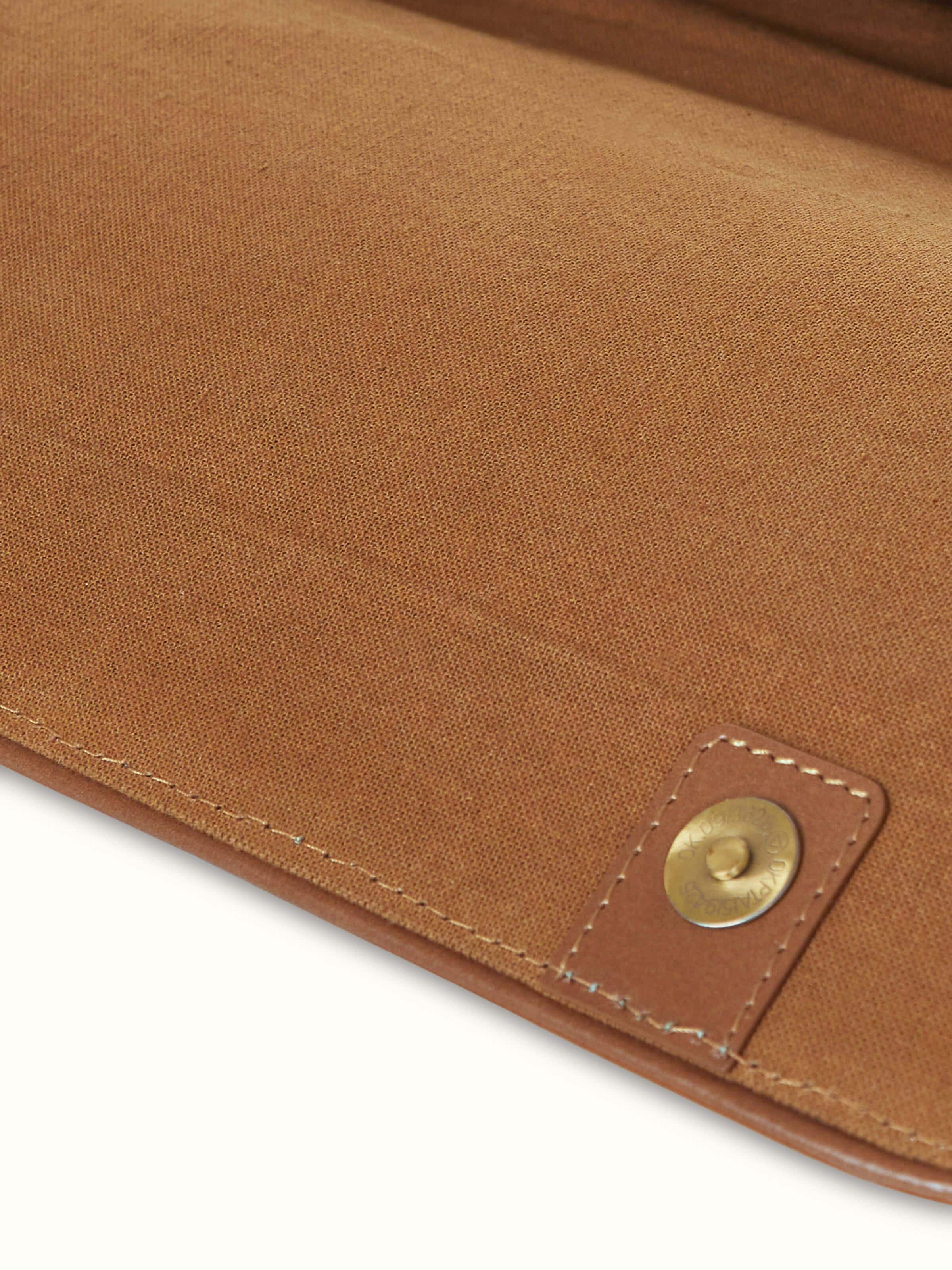 Angled view of Leather laptop bag emphasizing its functional compartments and design.