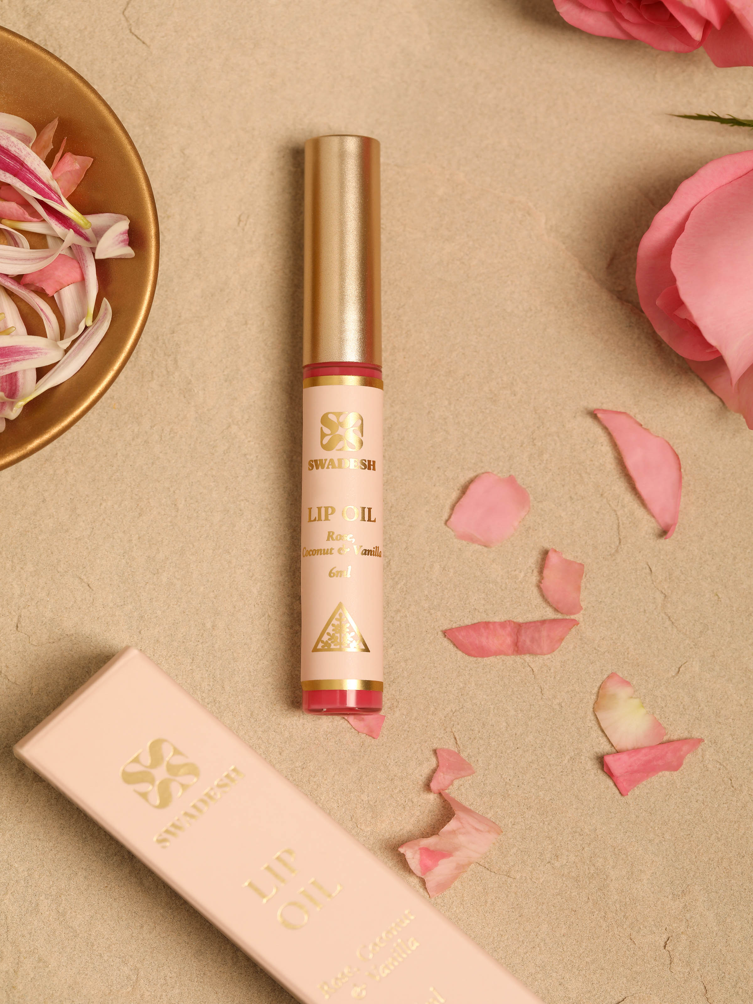 Side view of Lip Oil Rose, Coconut & Vanilla highlighting the texture of the oil and applicator design