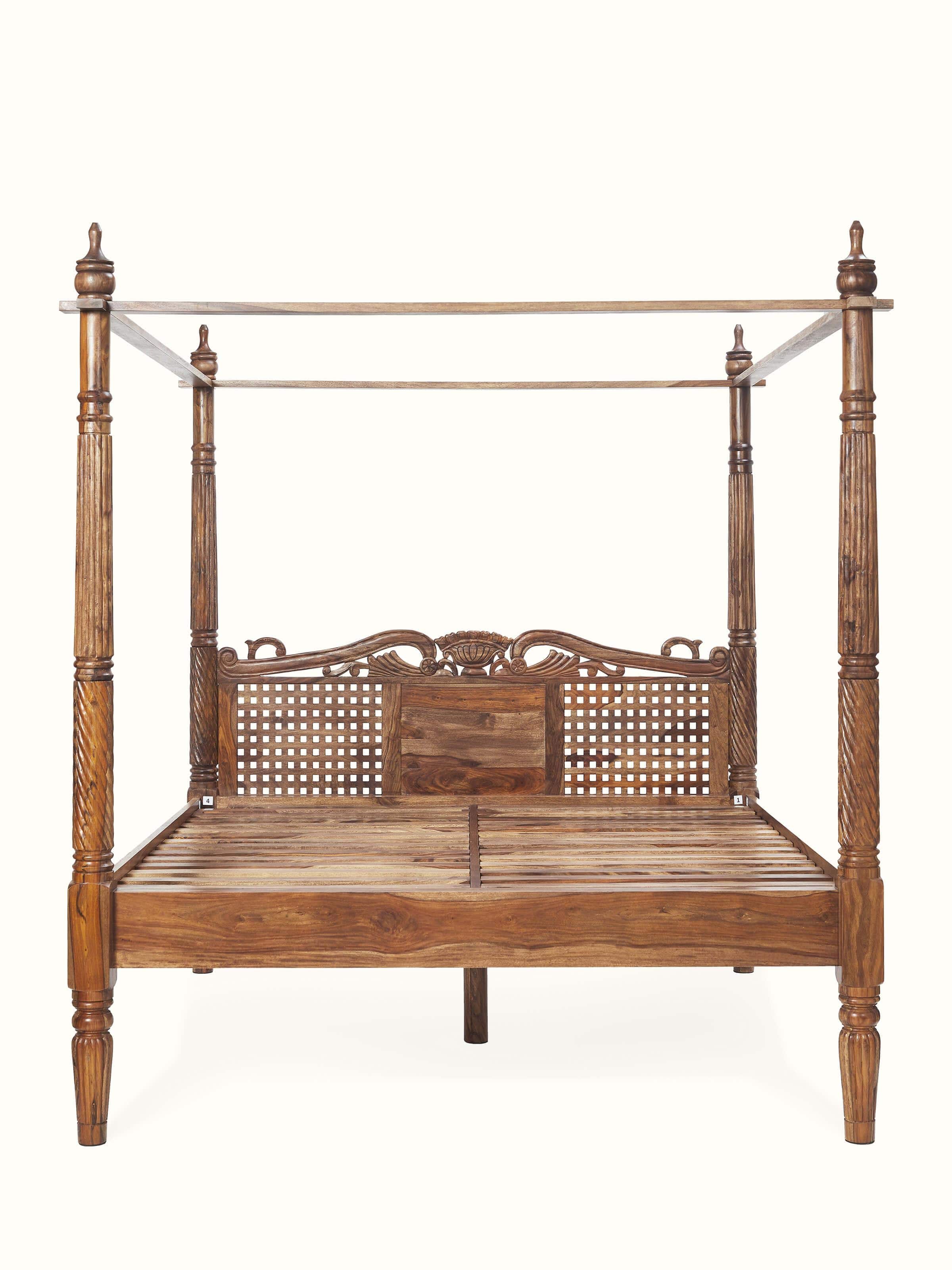 Front view of carved Sheesham wood poster bed, showcasing its detailed craftsmanship and elegant design.