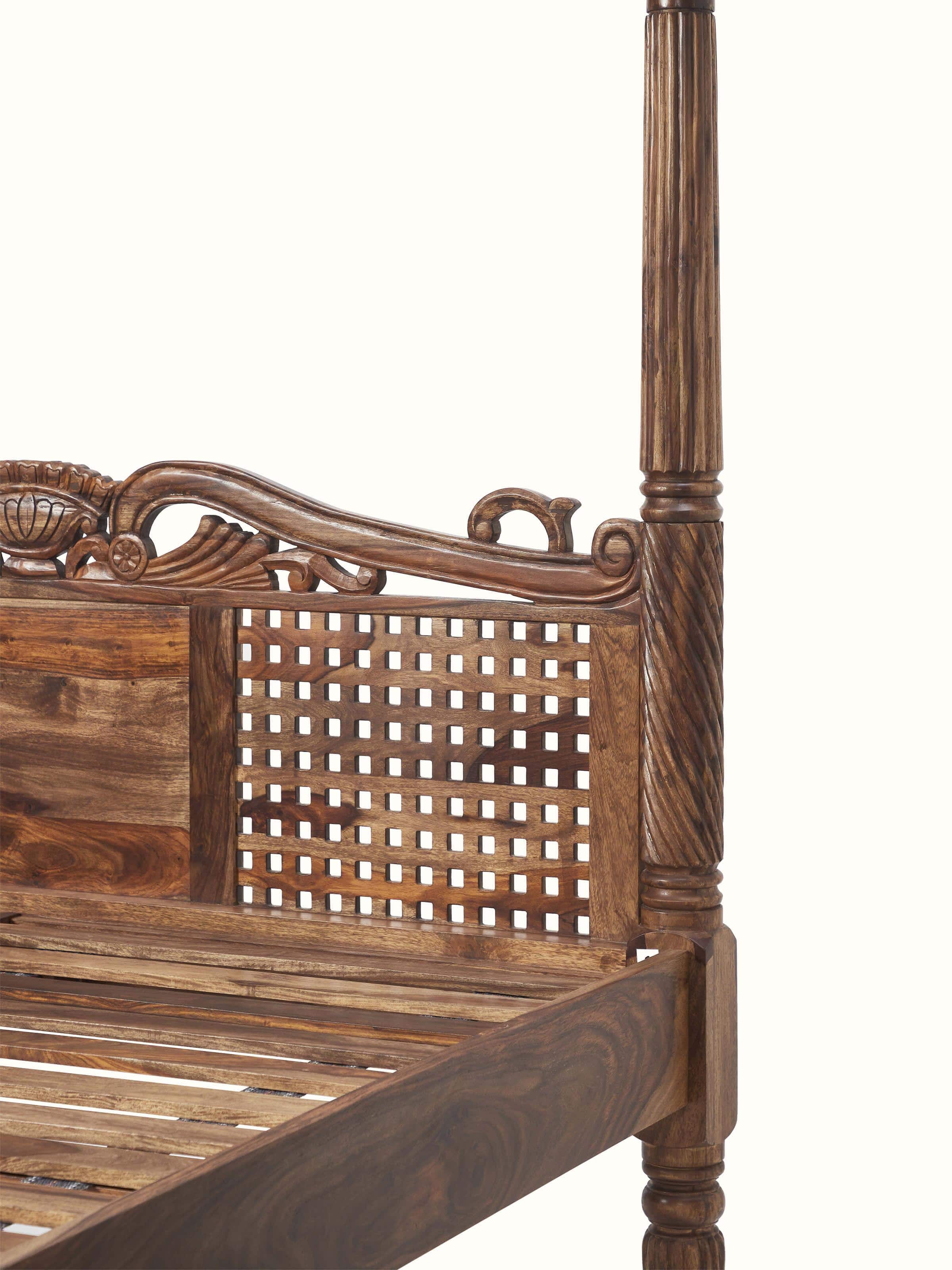 Detailed view of the Sheesham wood poster bed, highlighting the carved patterns and quality of the wood.