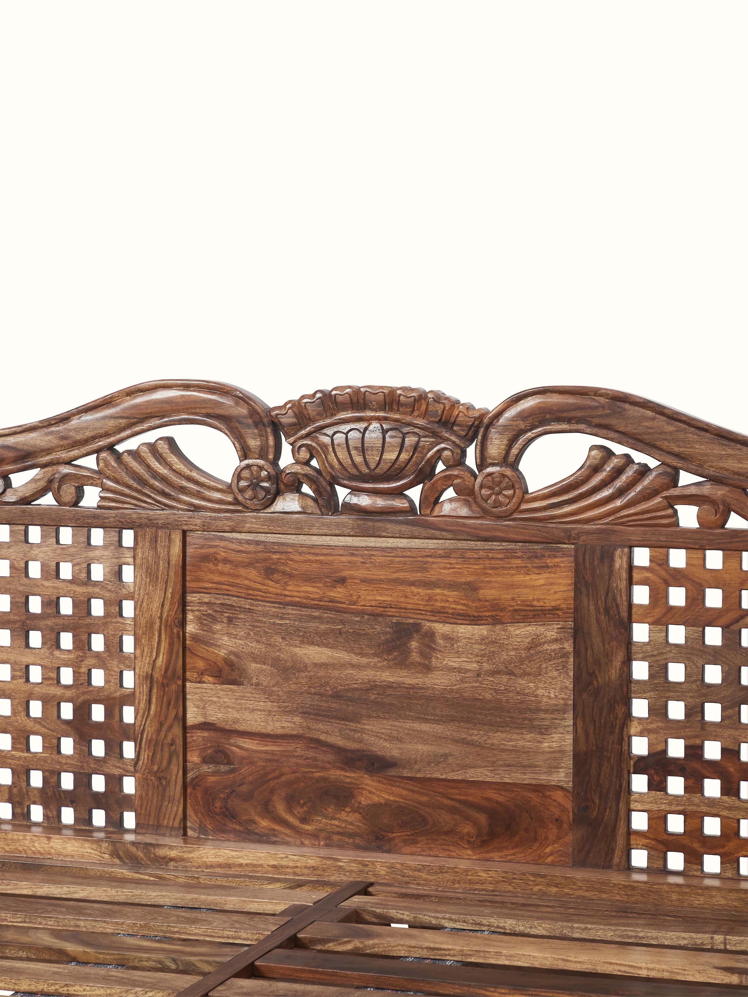 Full view of the carved Sheesham wood poster bed, showcasing its majestic and traditional design.