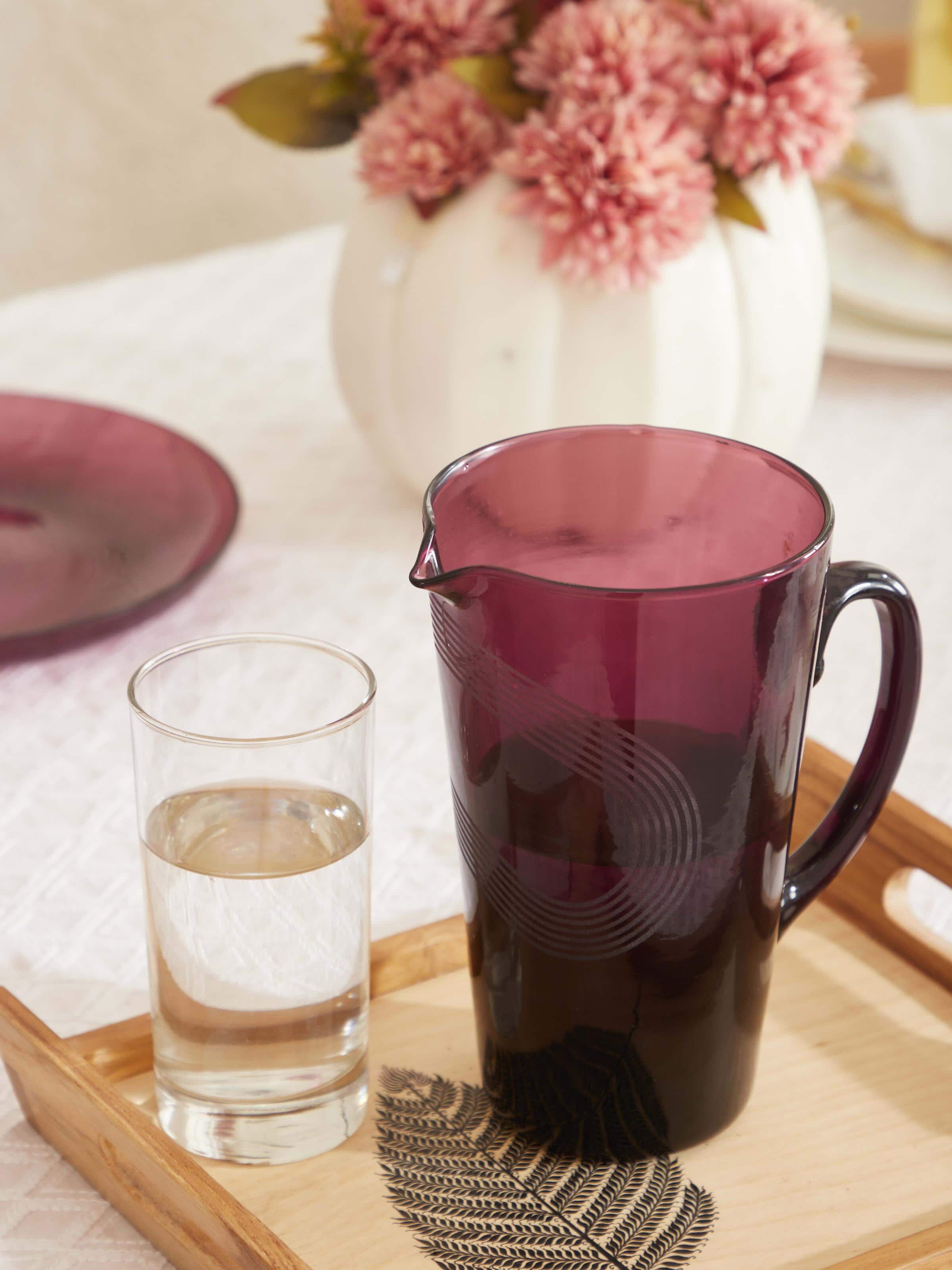 Side view of Firozabadi glass pitcher in purple showcasing its smooth finish and distinctive design.