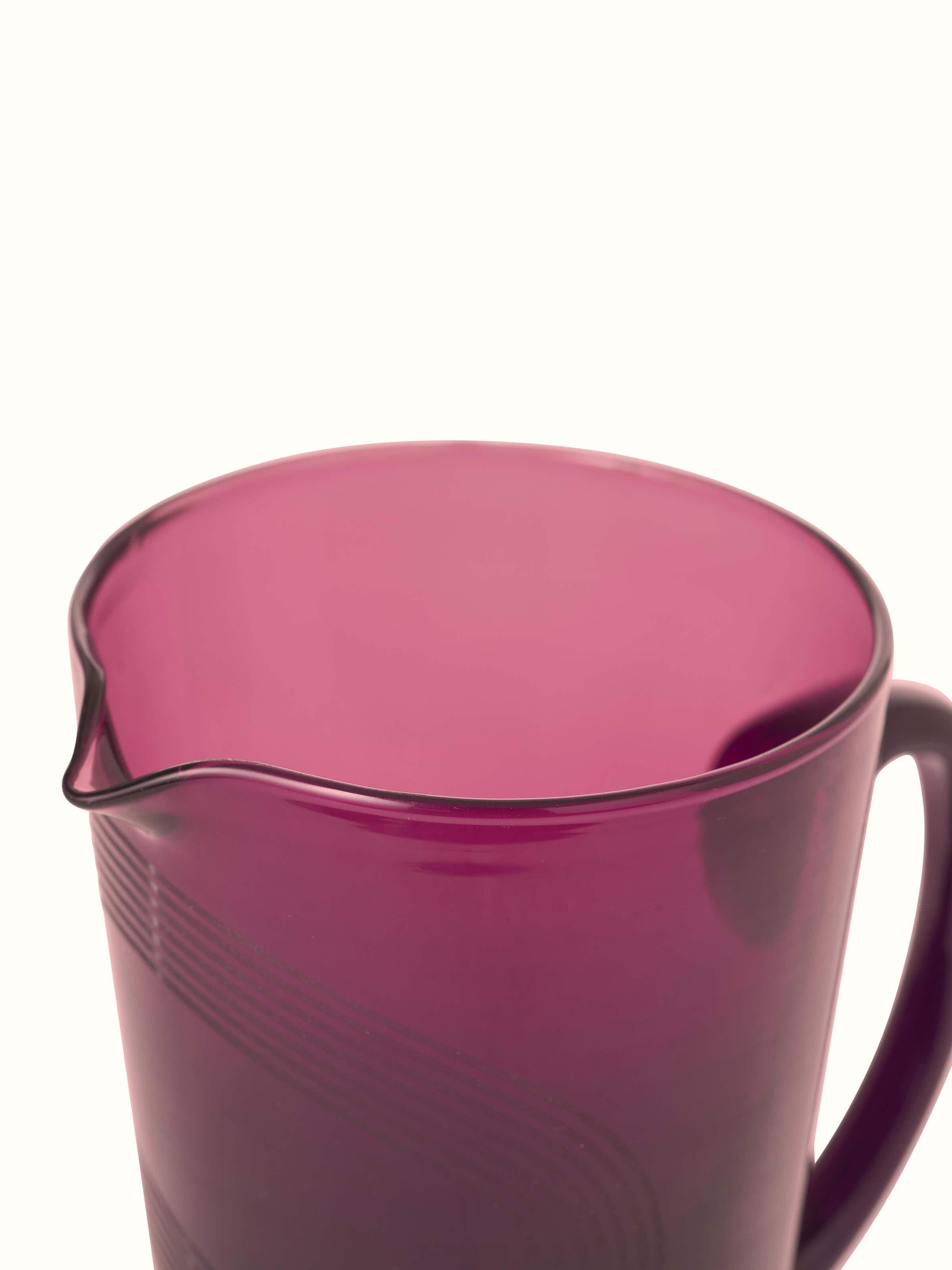 Close-up view of Firozabadi glass pitcher in purple focusing on the quality of the glass and color depth.