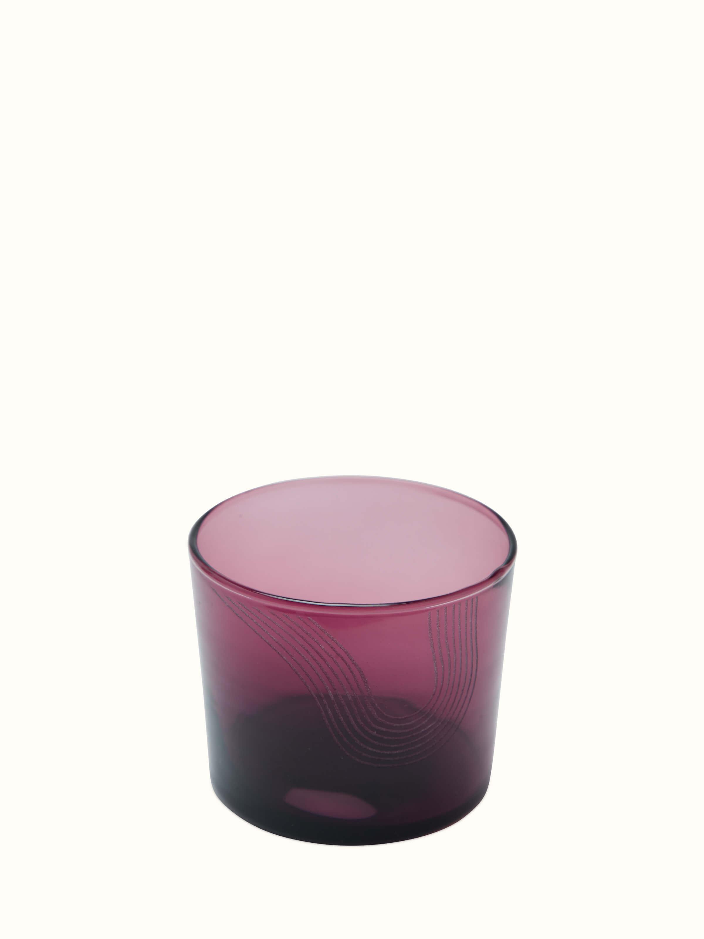 Side view of Firozabadi glass carafe in purple highlighting the refined glass finish