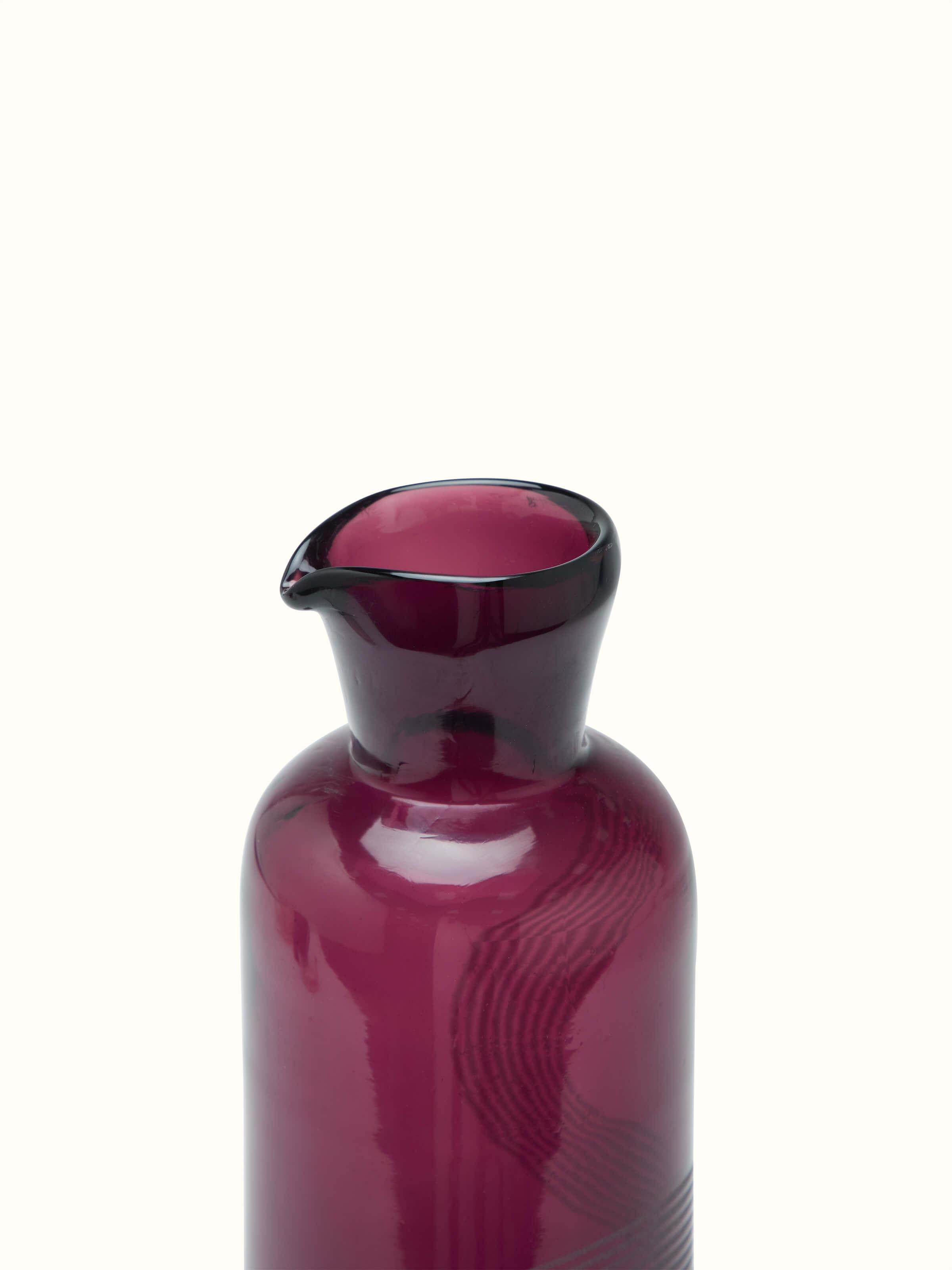 Side close-up of Firozabadi glass carafe in purple showing detailed design and color