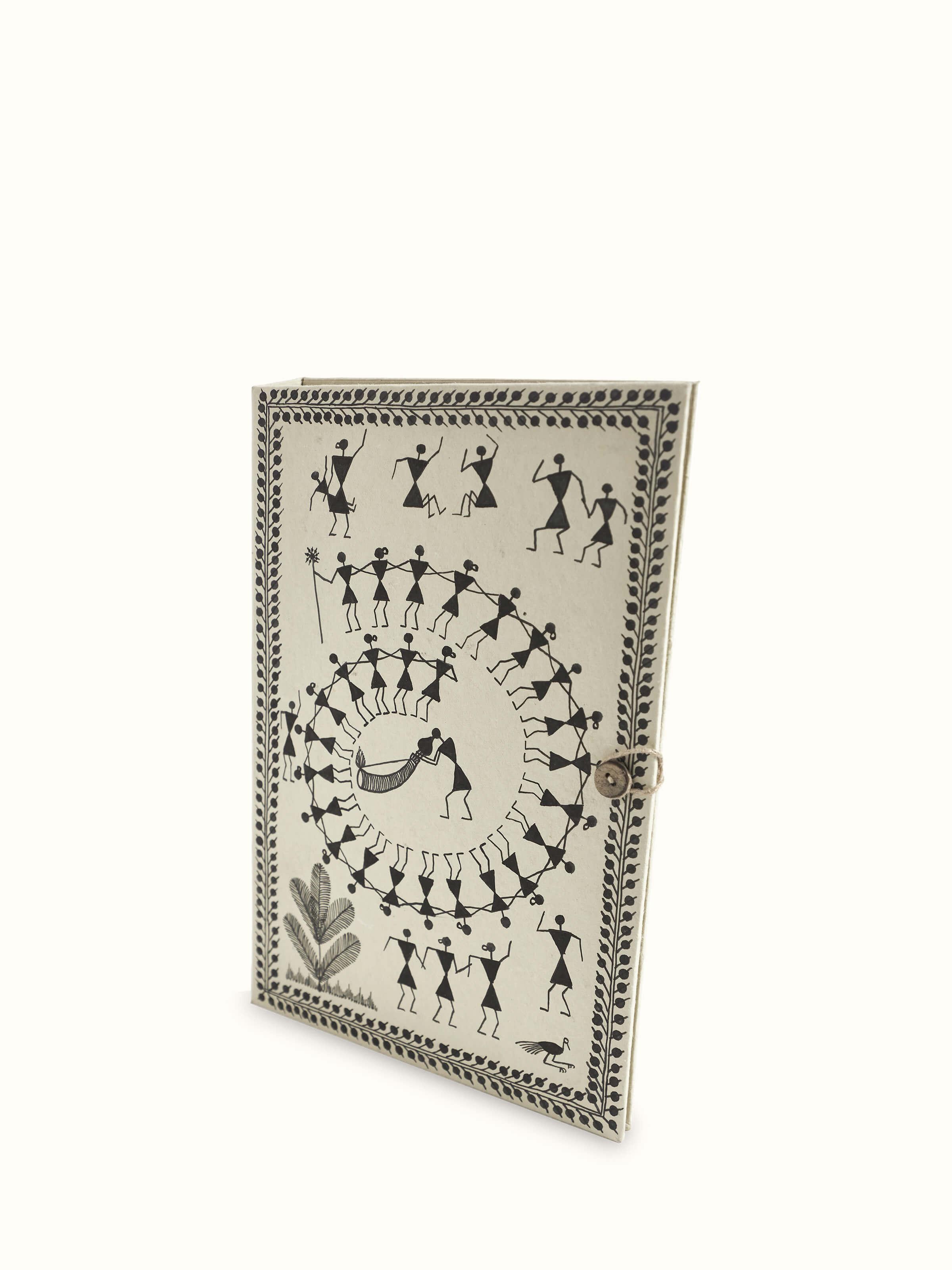 Angled view of Warli painted paper file folder in brown, showcasing intricate Warli paintings and craftsmanship