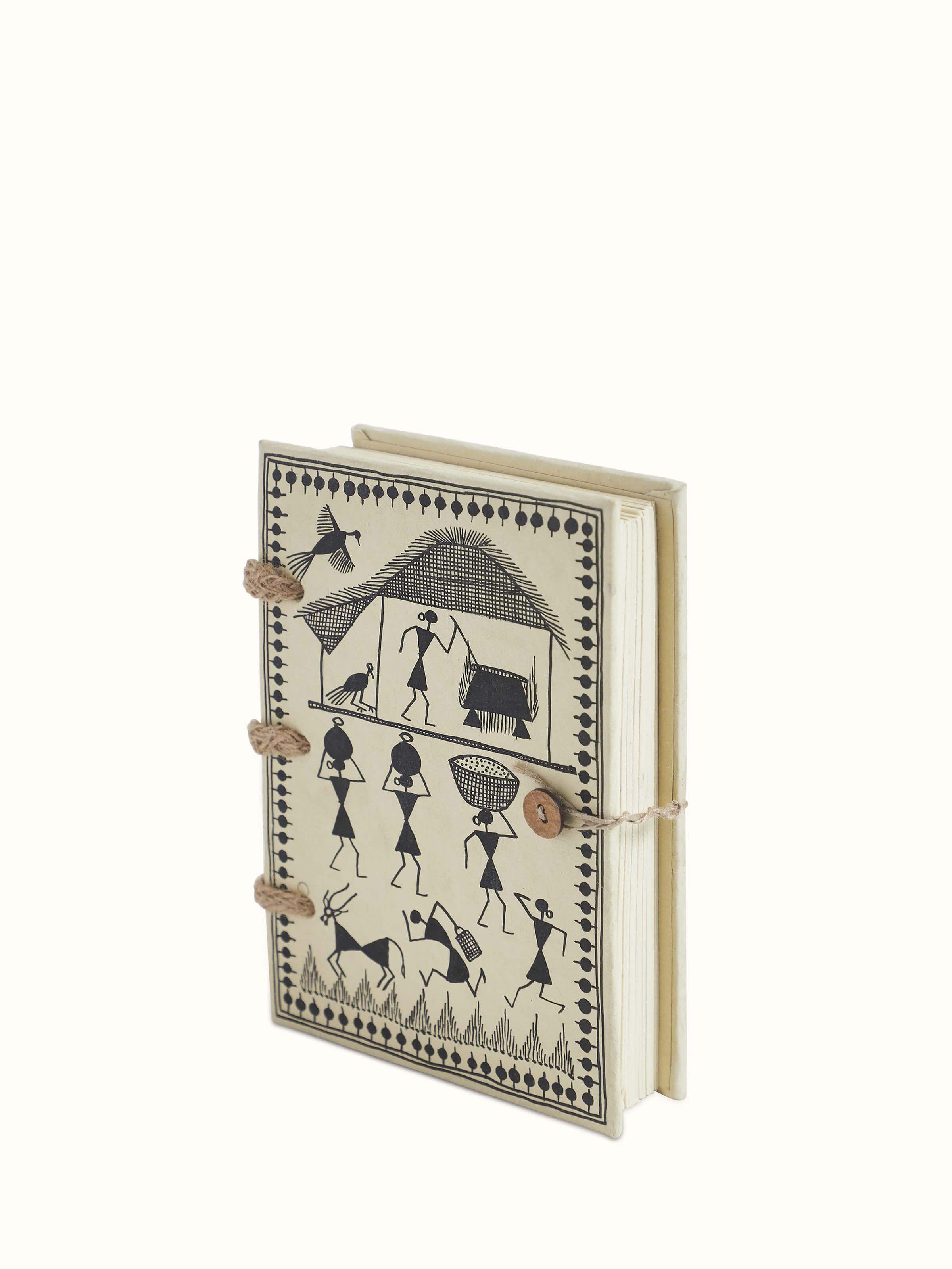 Close-up of Warli painted paper planner brown focusing on its detailed Warli paintings and texture
