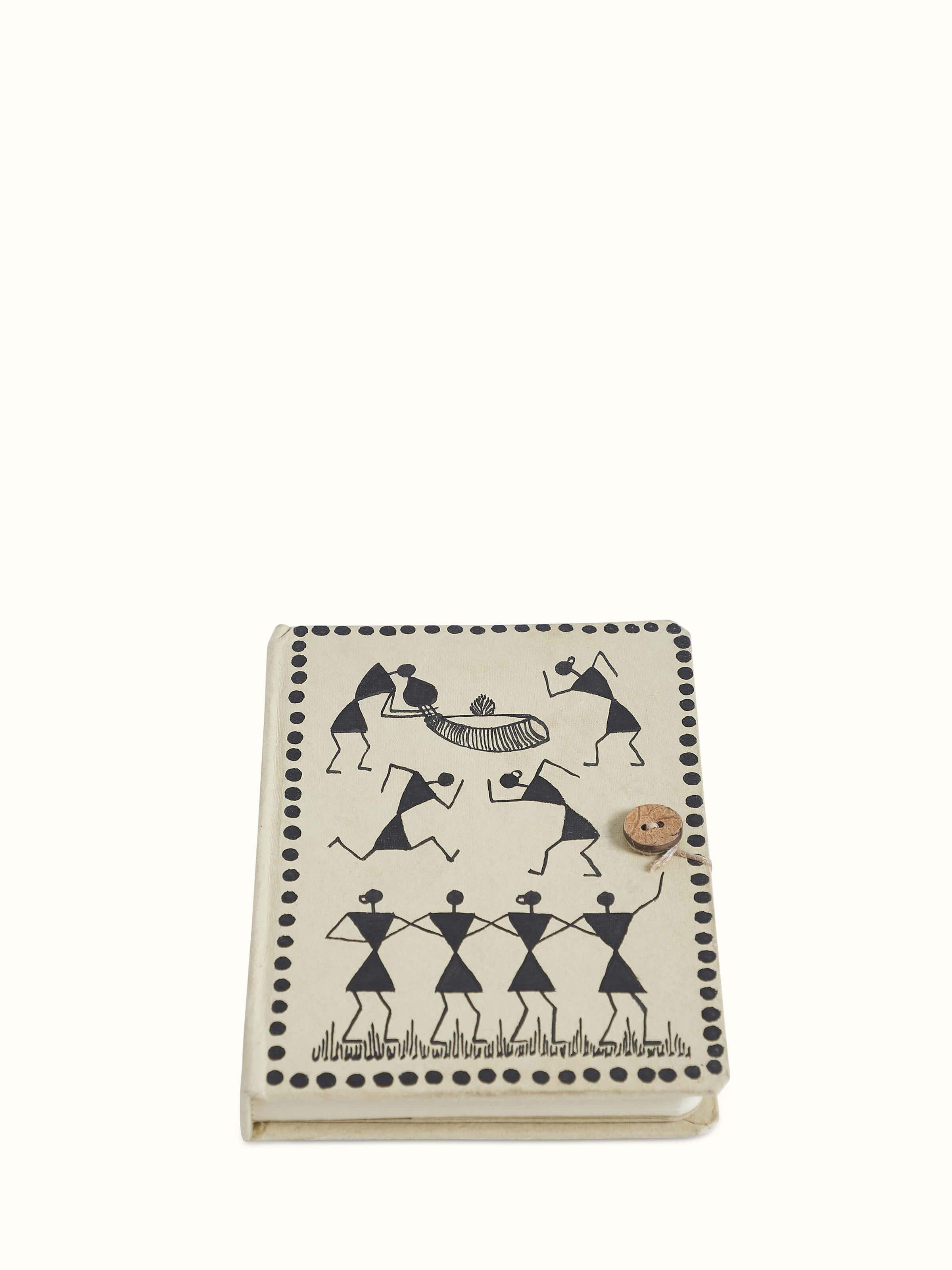 Front view of Warli painted paper journal in brown showcasing its traditional Warli artwork and textured cover