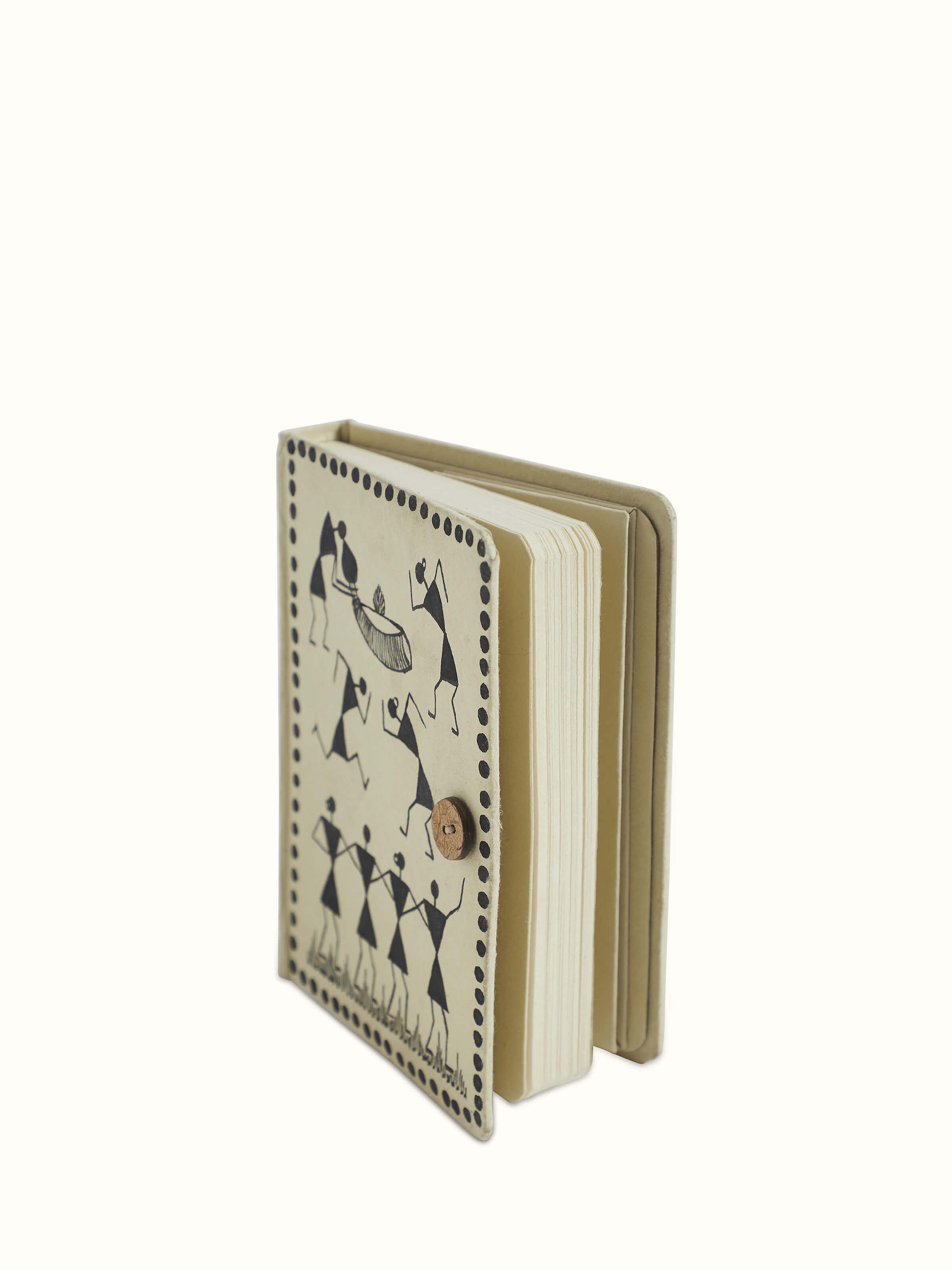 Detailed view of Warli painted paper journal in brown highlighting the texture and quality of the handmade paper