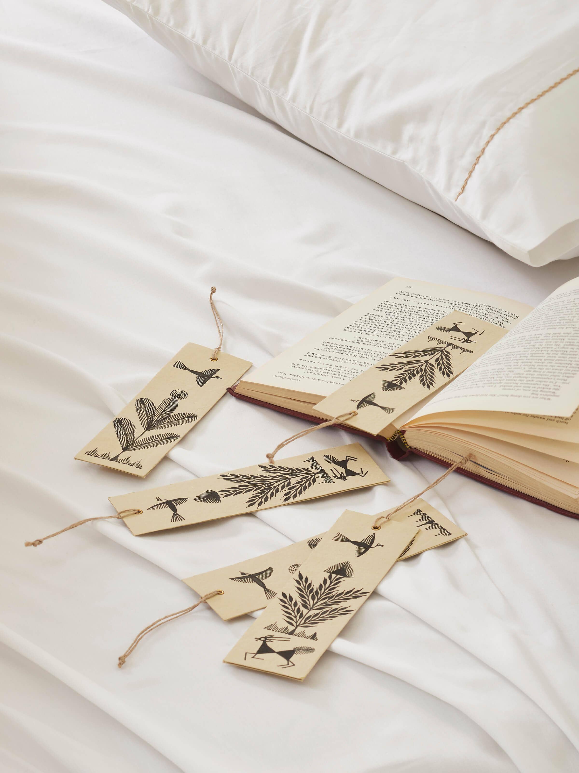 Side view of Warli painted paper bookmarks in brown (2 pcs) illustrating the thickness and craftsmanship.