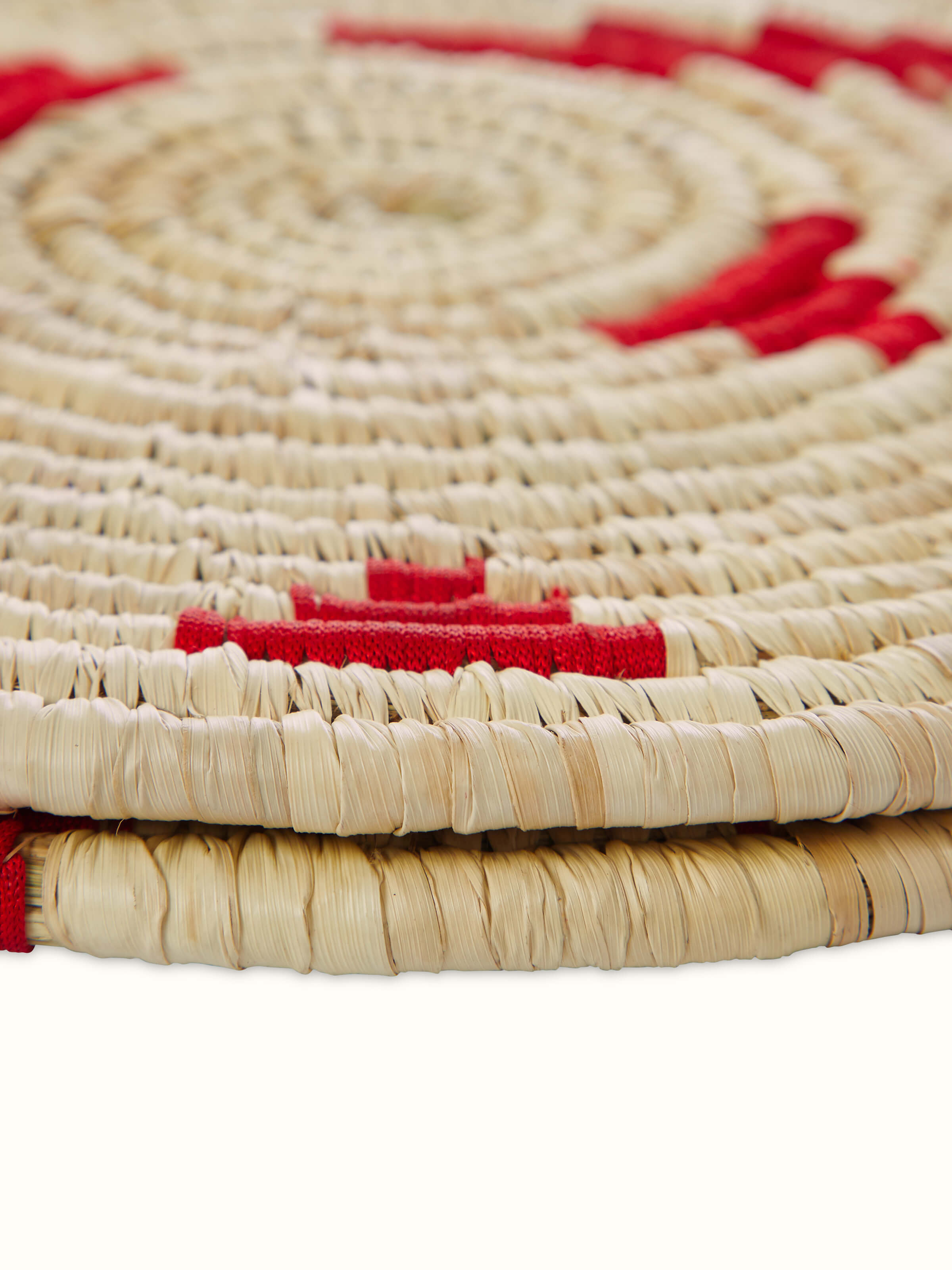 Close-up view of Kanshi Basketry Natural Fibre Trivets in red (2 pcs) emphasizing the texture and details of the fibre.