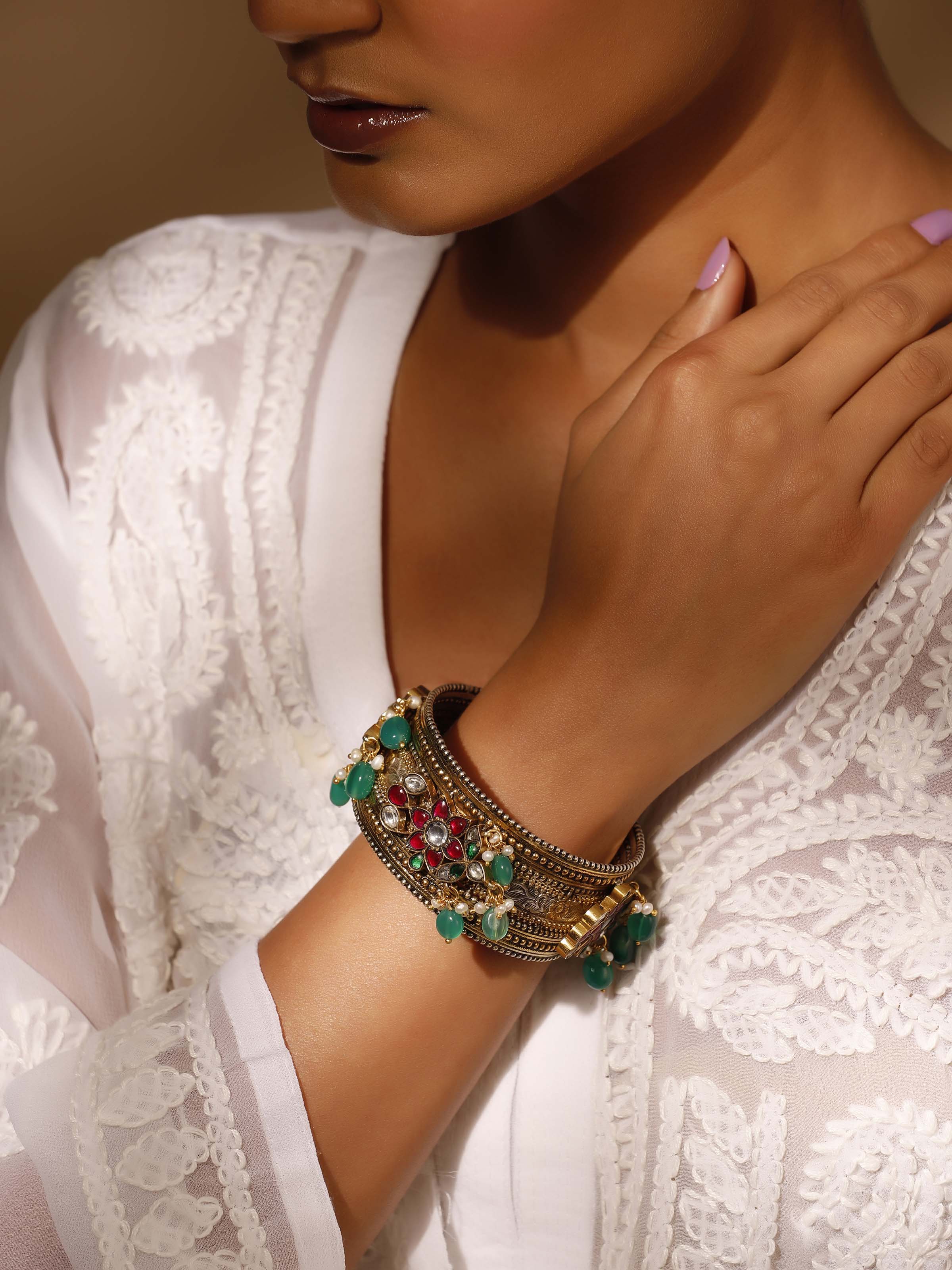 Angled view of silver smithing bangle highlighting the high-quality metal and design.