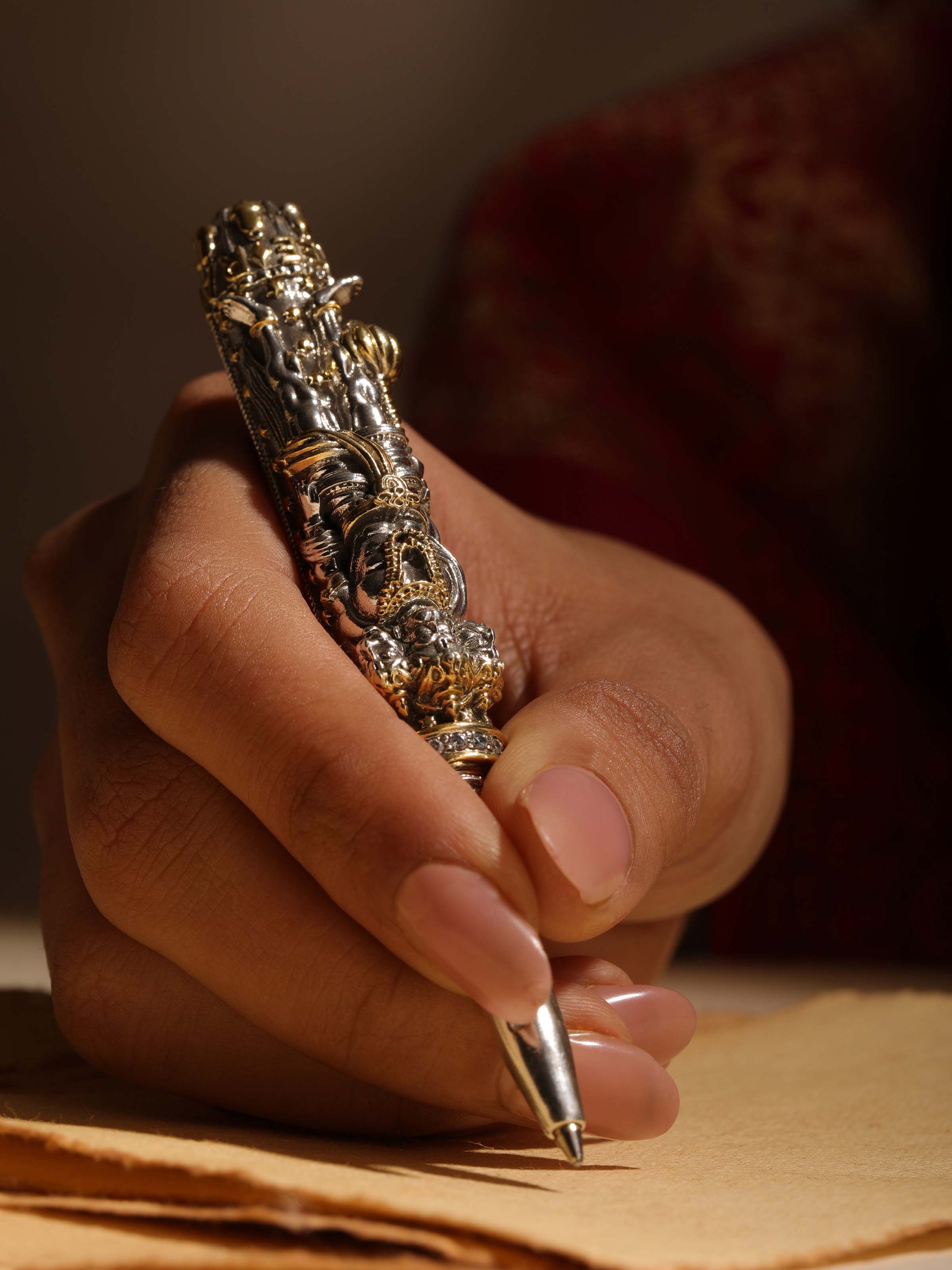 Close-up of Lord Hanuman Silver Smithing Pen showing detailed silver craftsmanship and fine engraving.