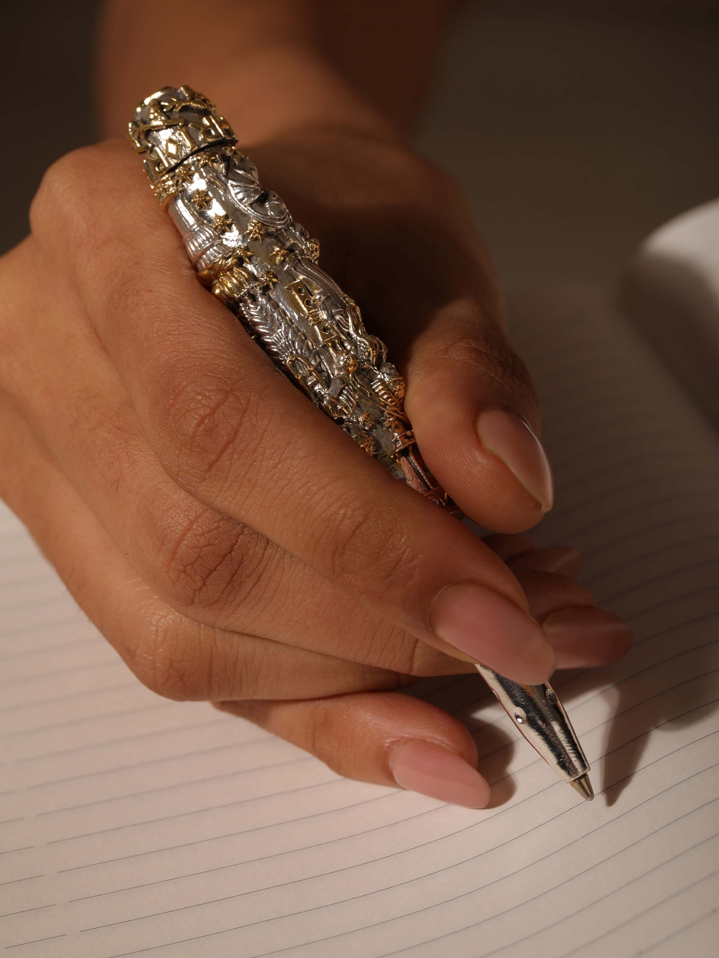 Close-up view of Figures Silver Smithing Pen highlighting intricate silver detailing and refined finish.