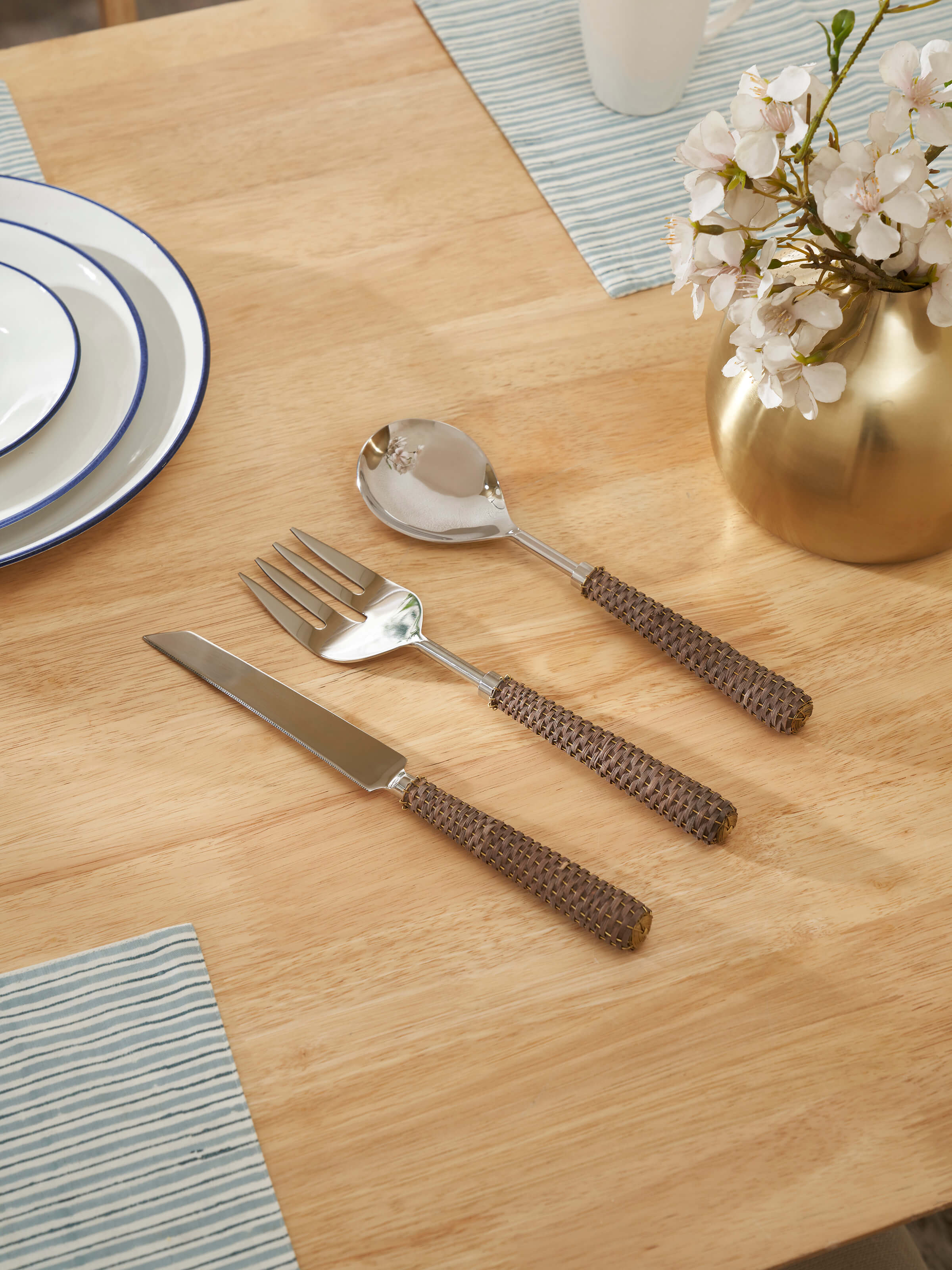 Side view of Rattan handle stainless steel cutlery set (3 pcs), emphasizing the sleek design and finish.