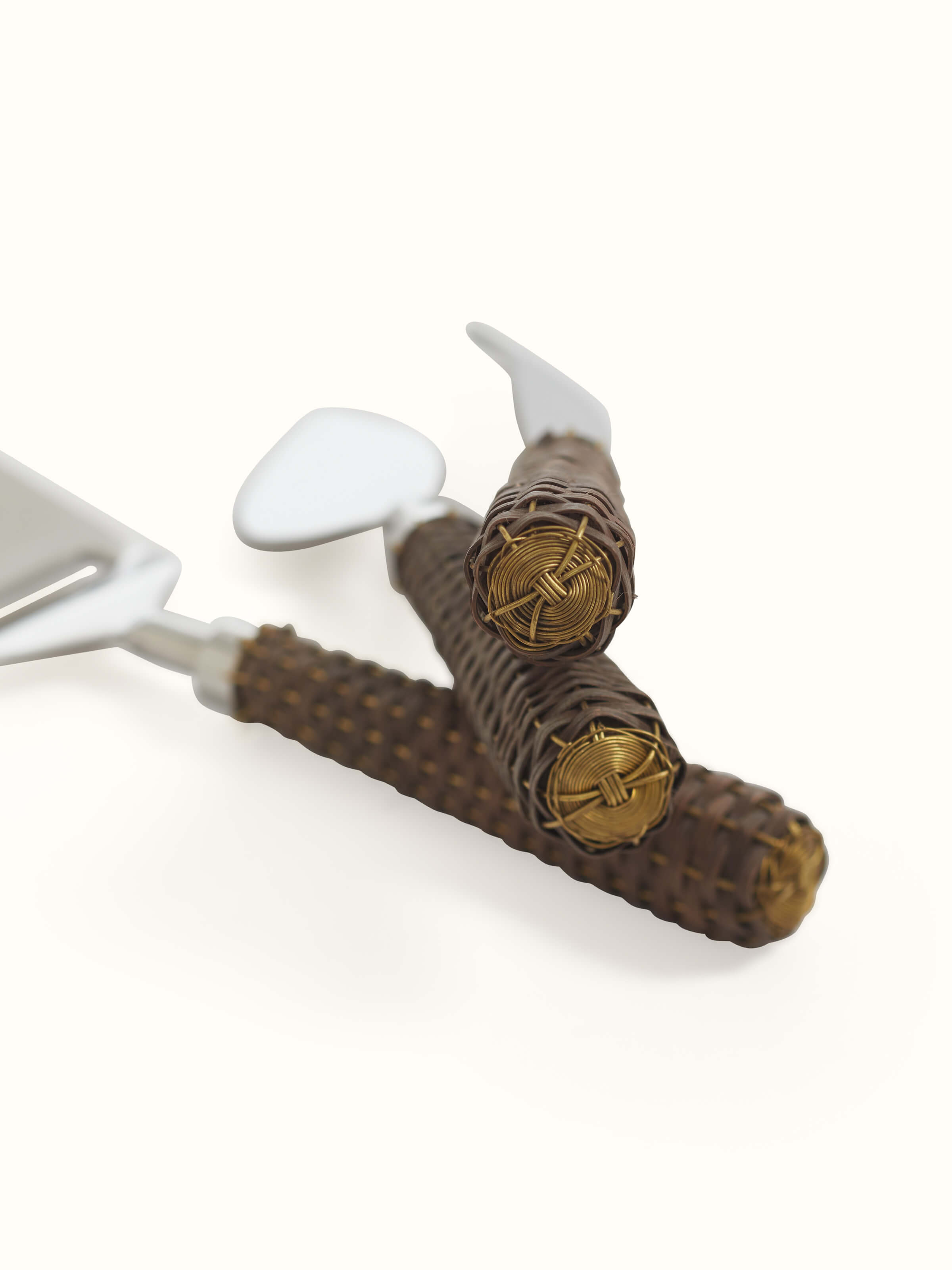 Top view of the stainless steel cheese knives with rattan handles, showcasing the arrangement and design of the set.