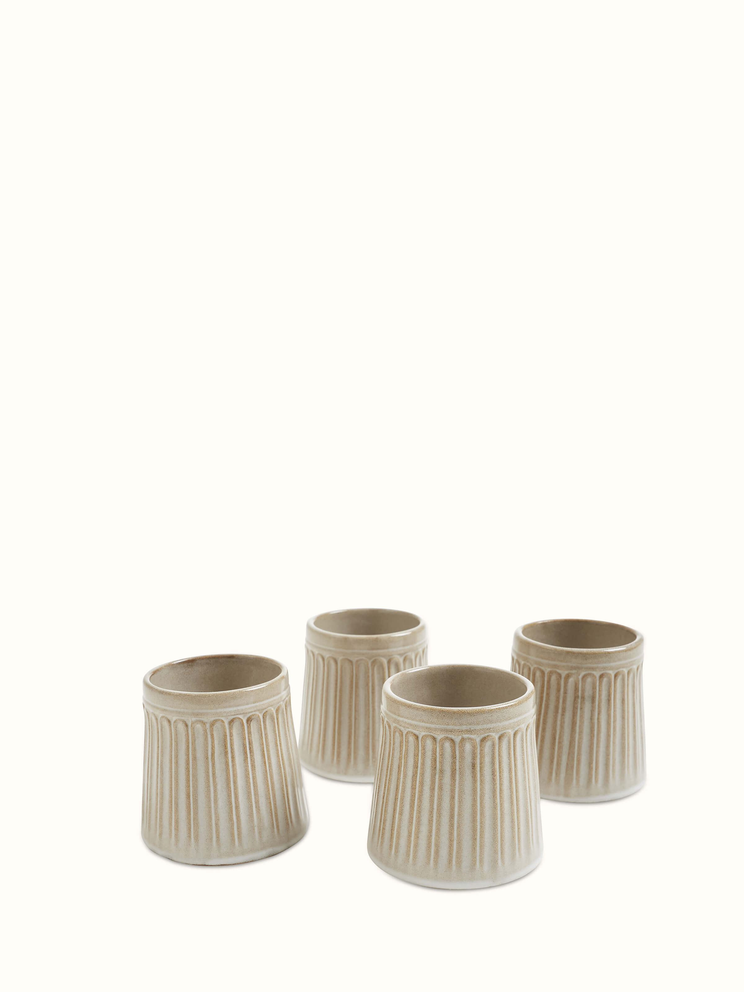 Beige studio pottery ceramic water tumblers set of four, showcasing a simple and elegant design.