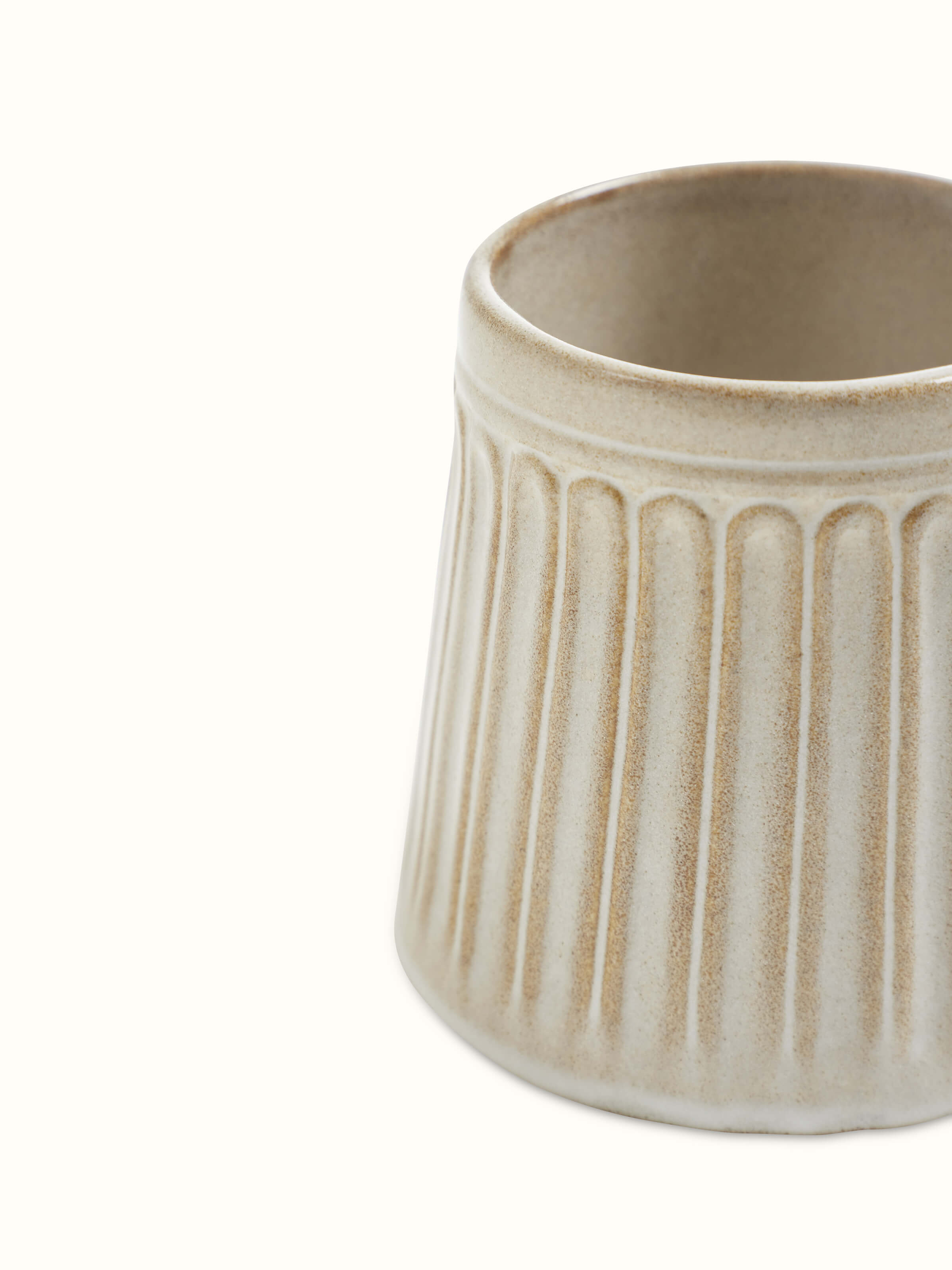Studio pottery ceramic water tumblers in beige, displayed to highlight their aesthetic appeal.