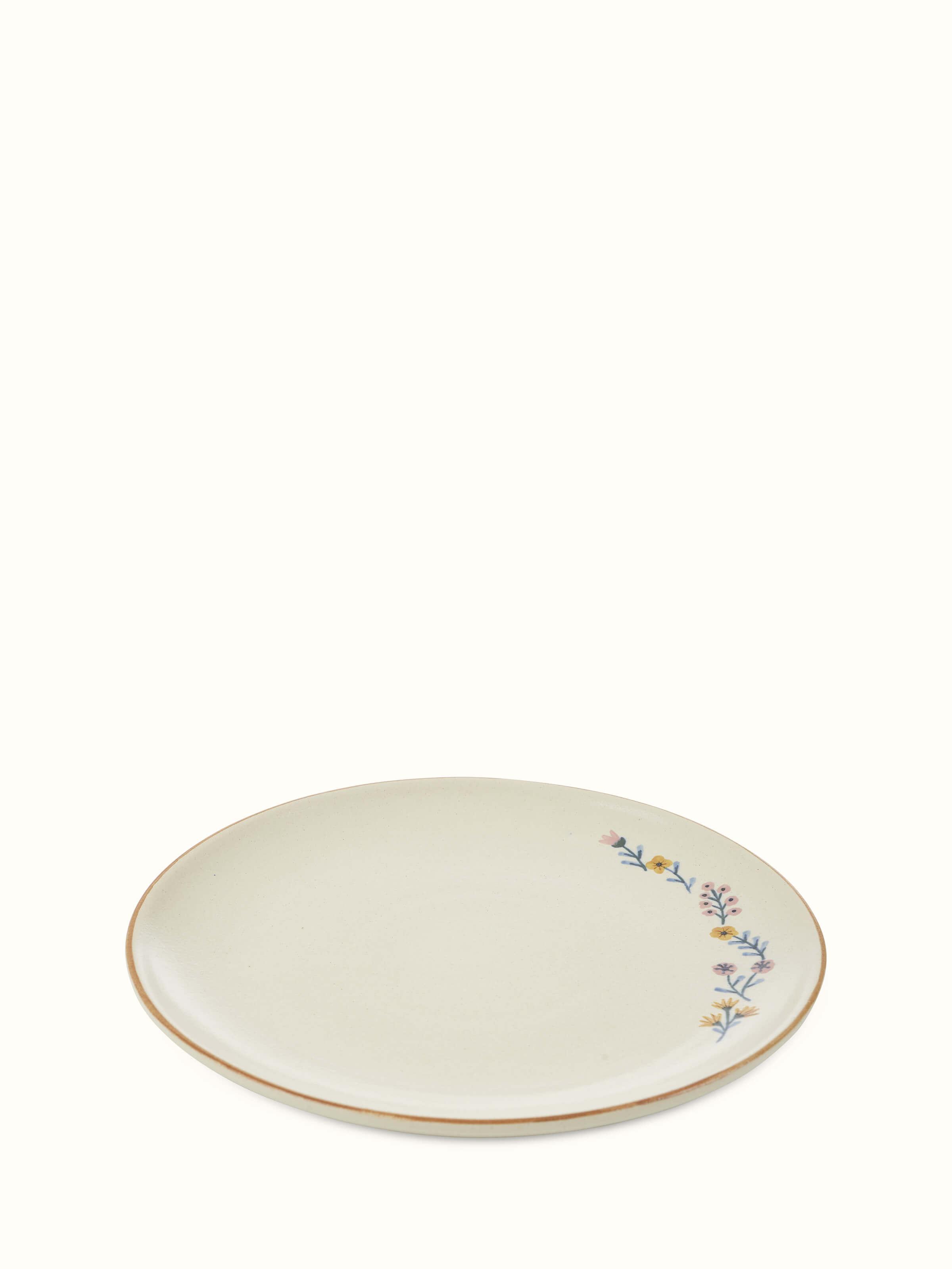 Top-down view of beige studio pottery ceramic dinner plates set of 4, emphasizing their round shape