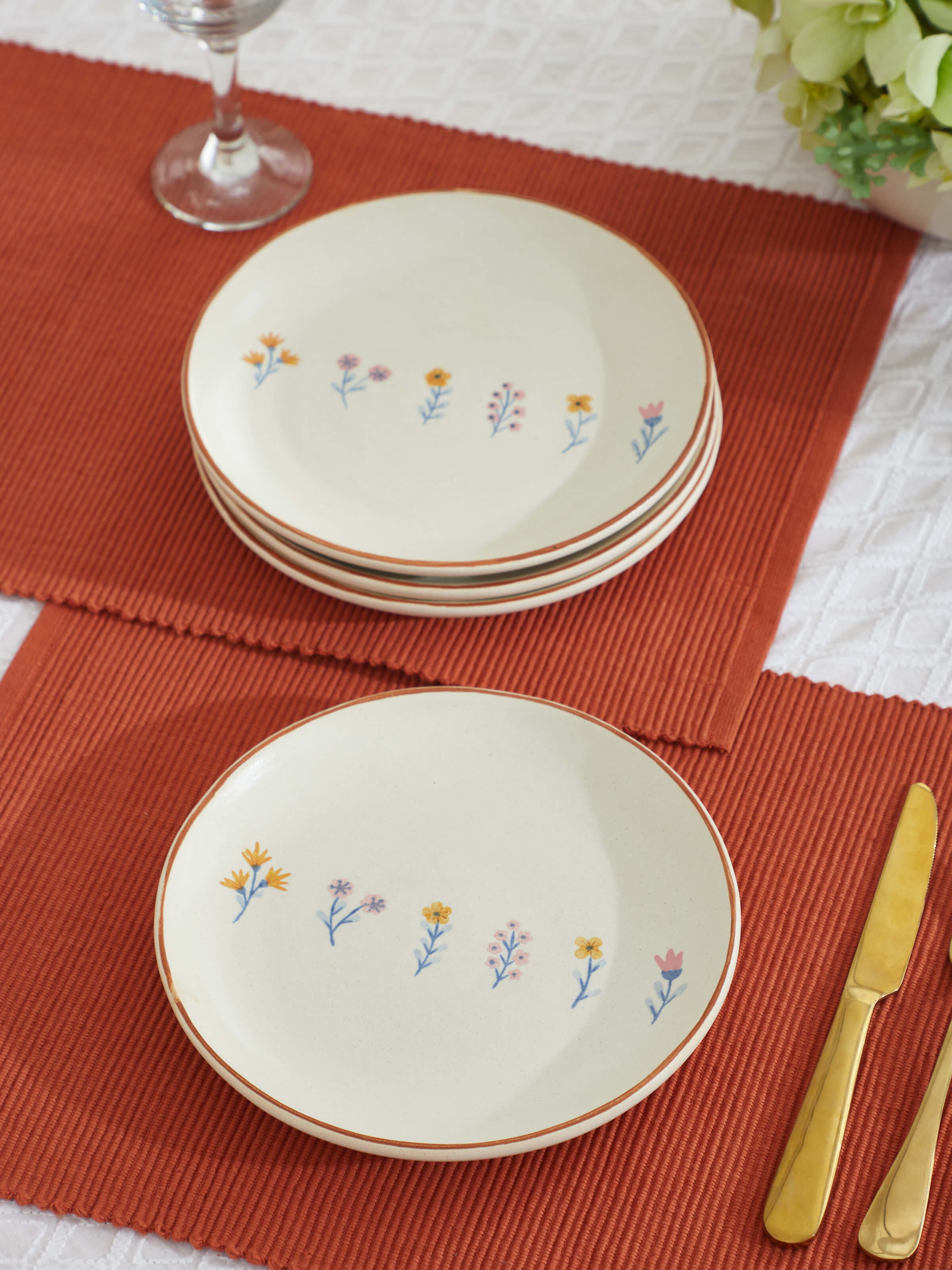 Side view of Studio pottery ceramic side plates in beige (4 pcs) highlighting texture
