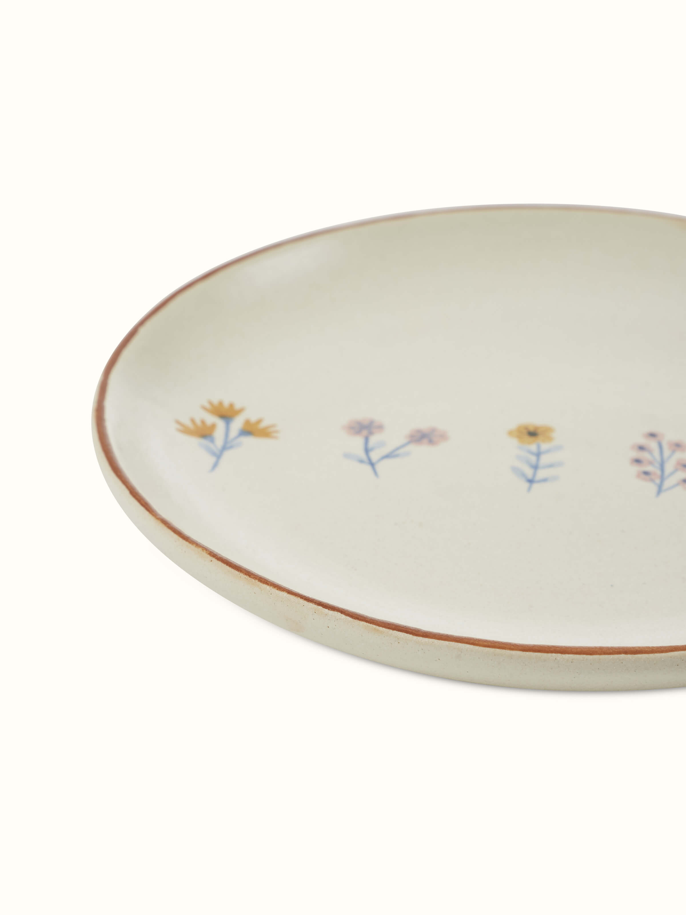 Angled view of Studio pottery ceramic side plates in beige (4 pcs) showcasing the finish