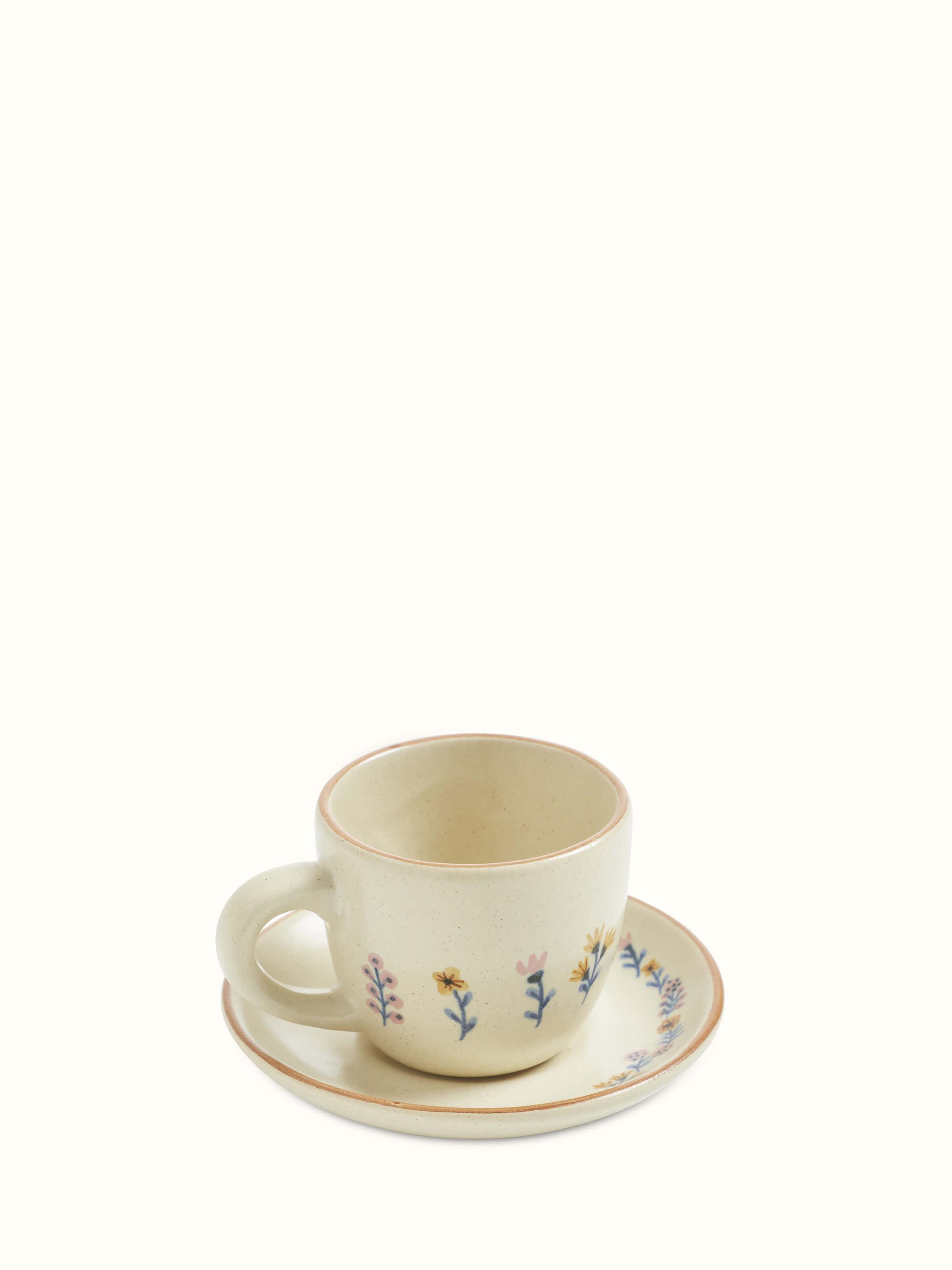 Close-up of studio pottery ceramic teacups set highlighting the texture