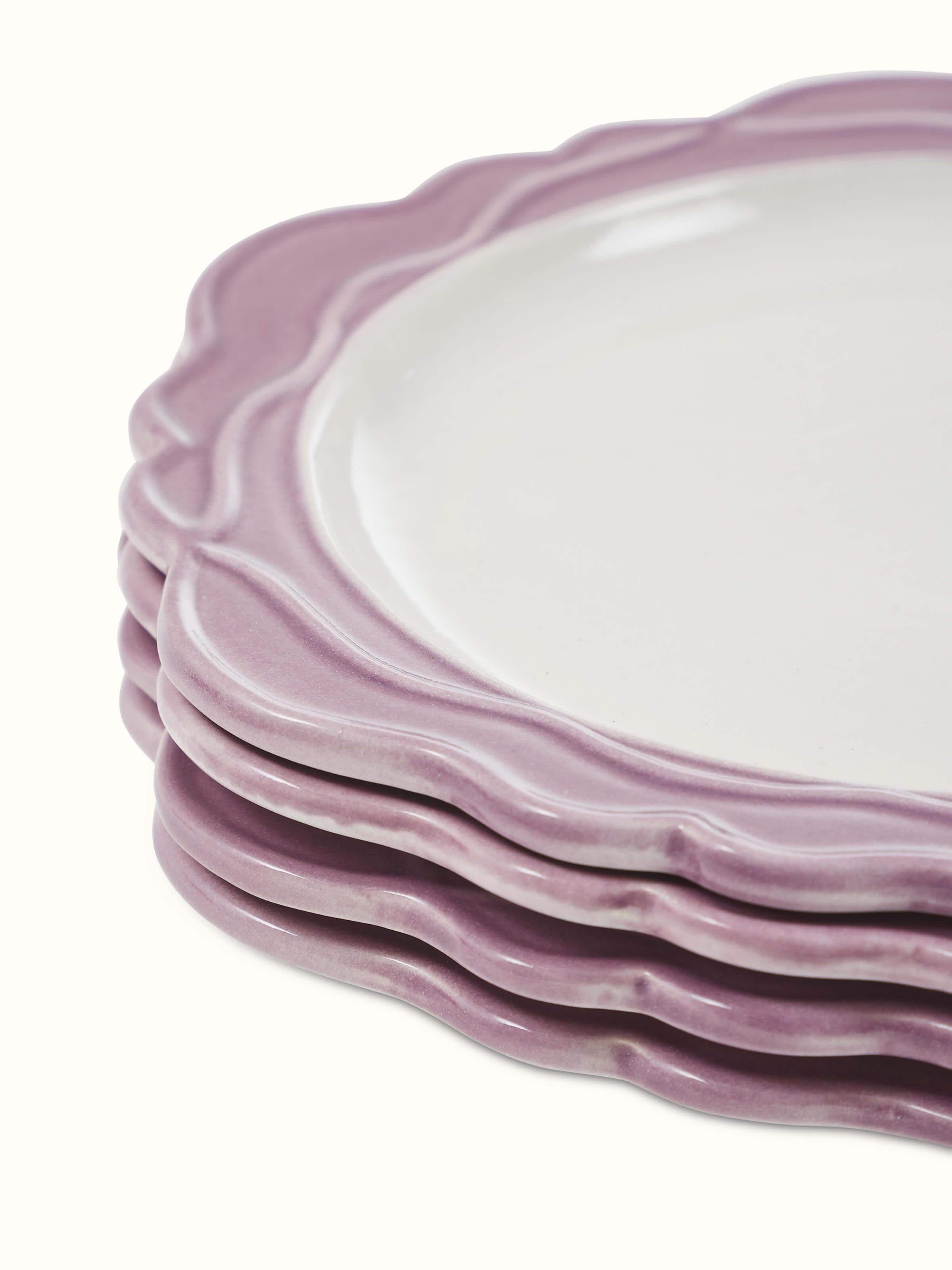 Close-up of studio pottery ceramic dinner plates in pink (4 pcs) showing detailed surface texture.