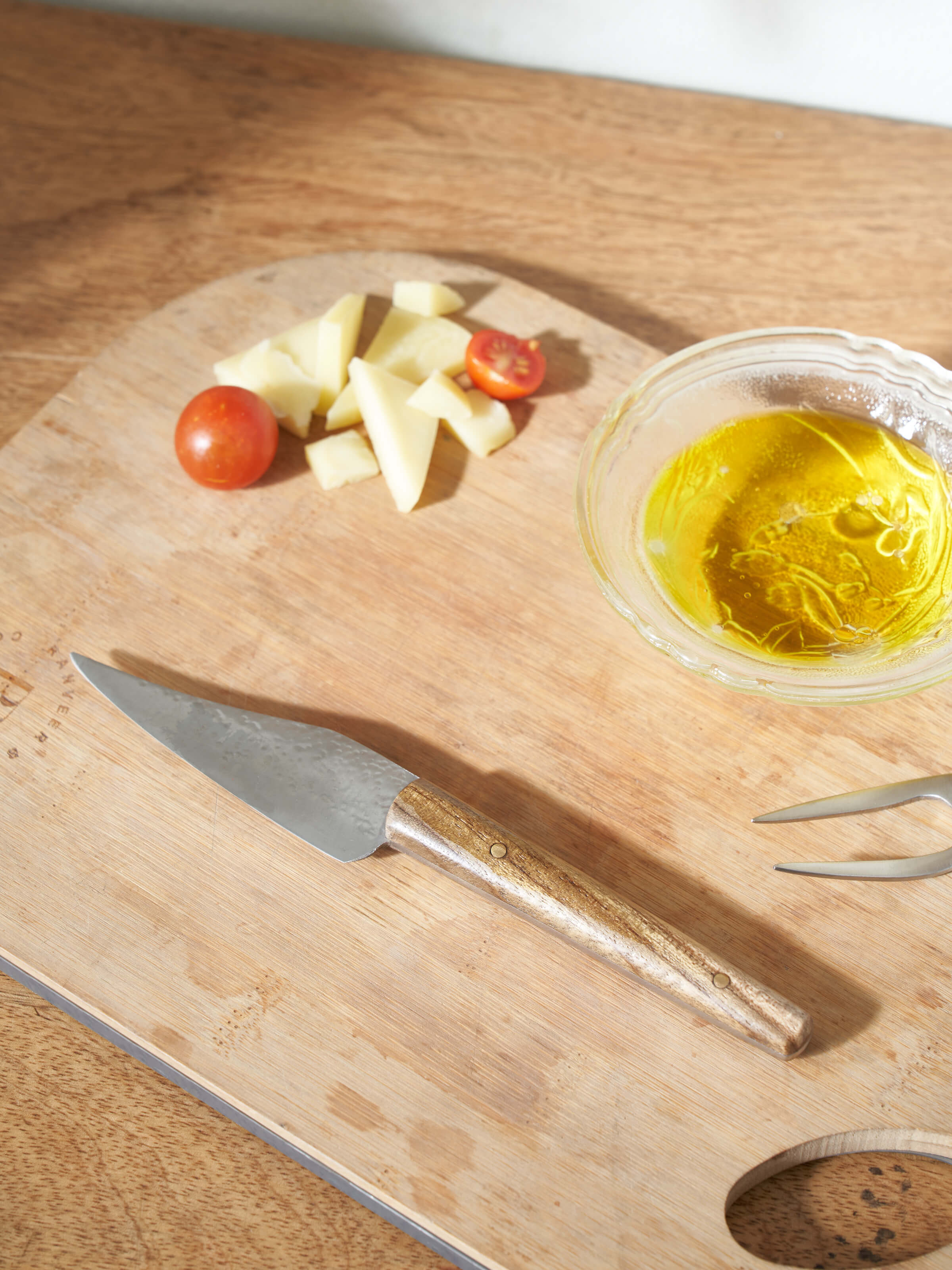 Side view of Reha stainless steel chef's knife focusing on the blade's sharpness and handle design.