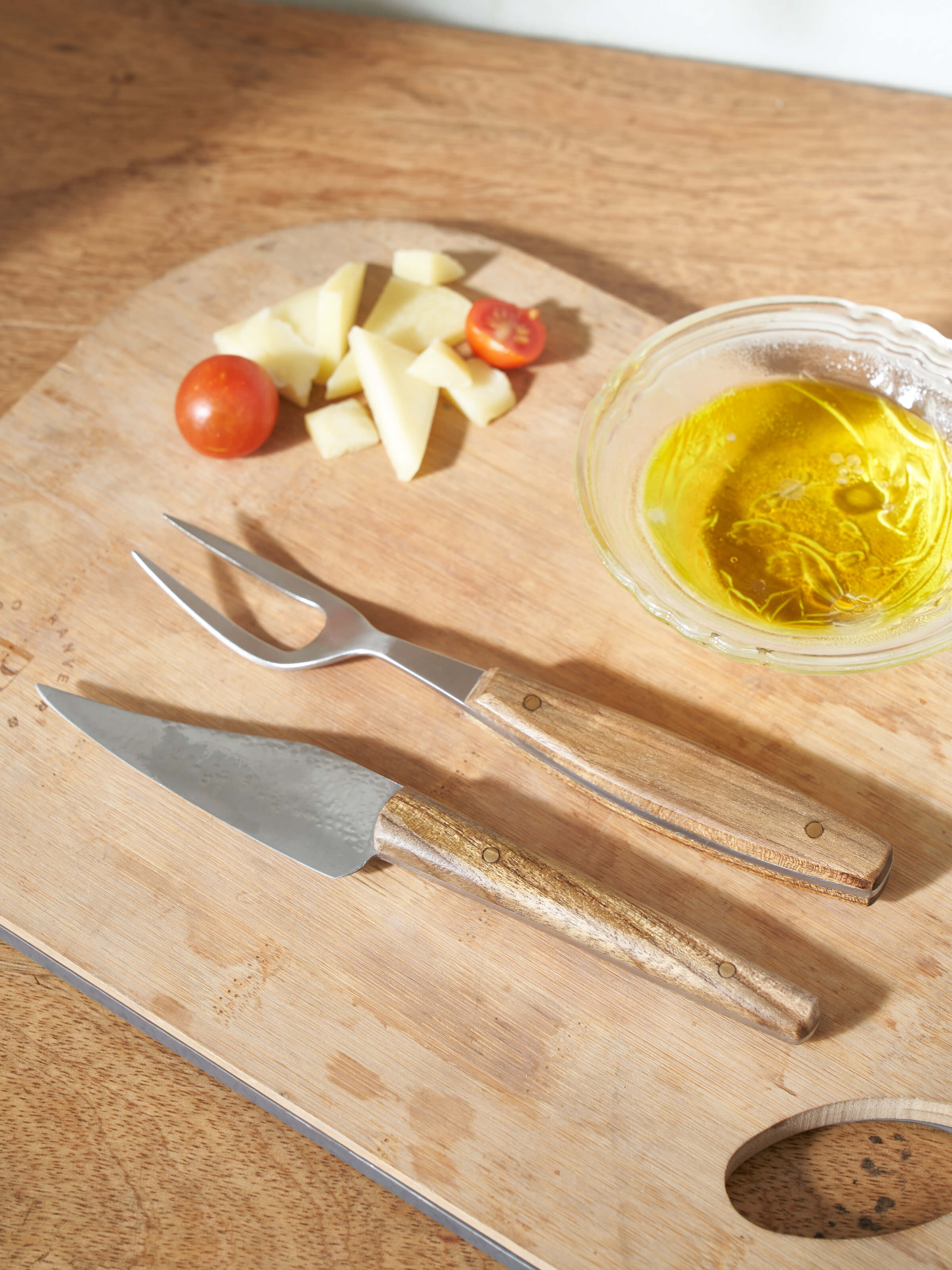 Detailed close-up of Reha stainless steel chef's knife highlighting the blade's edge and finish.