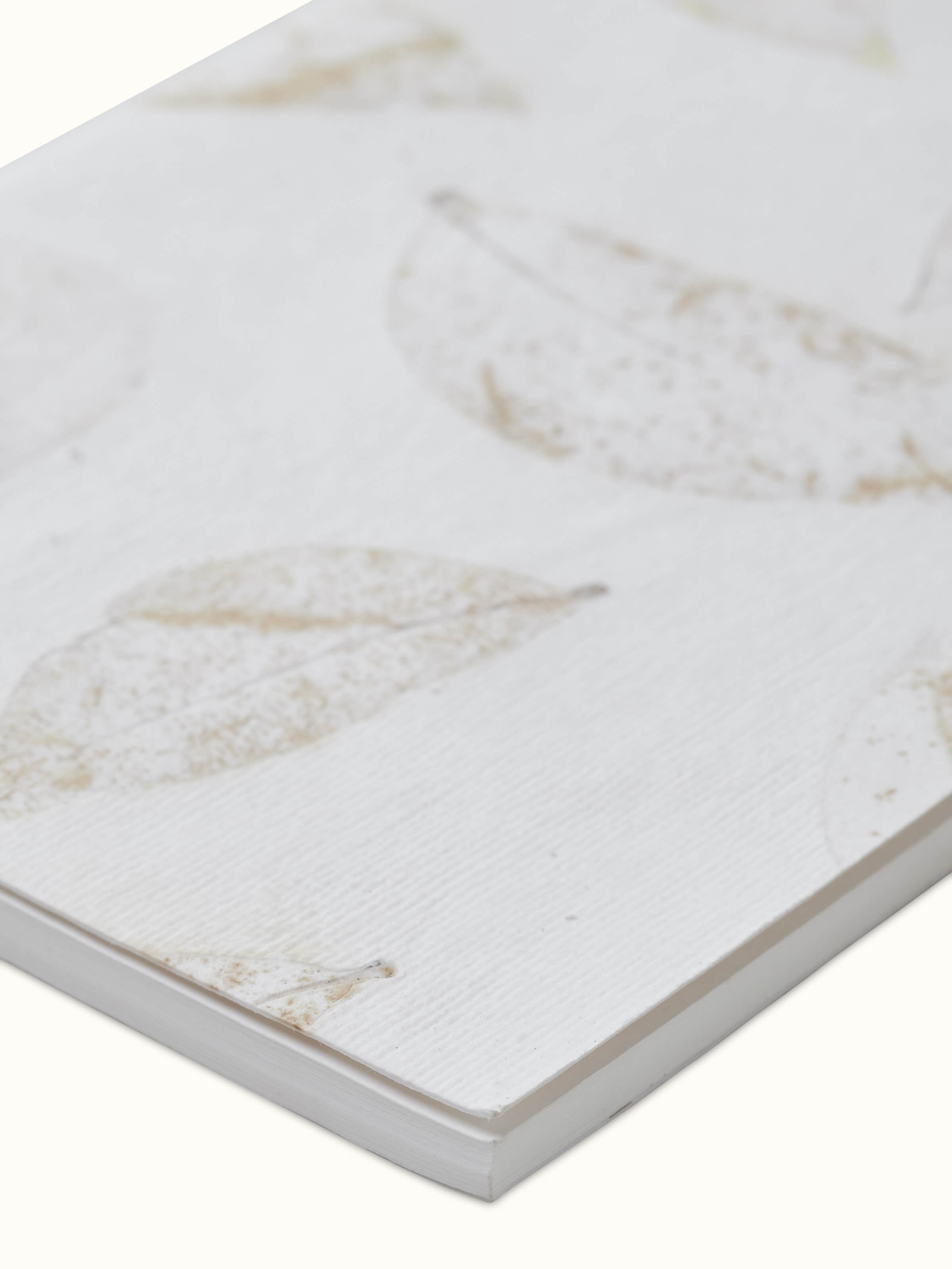 Side view of Auroville handmade paper notebook white (40 sheets)
