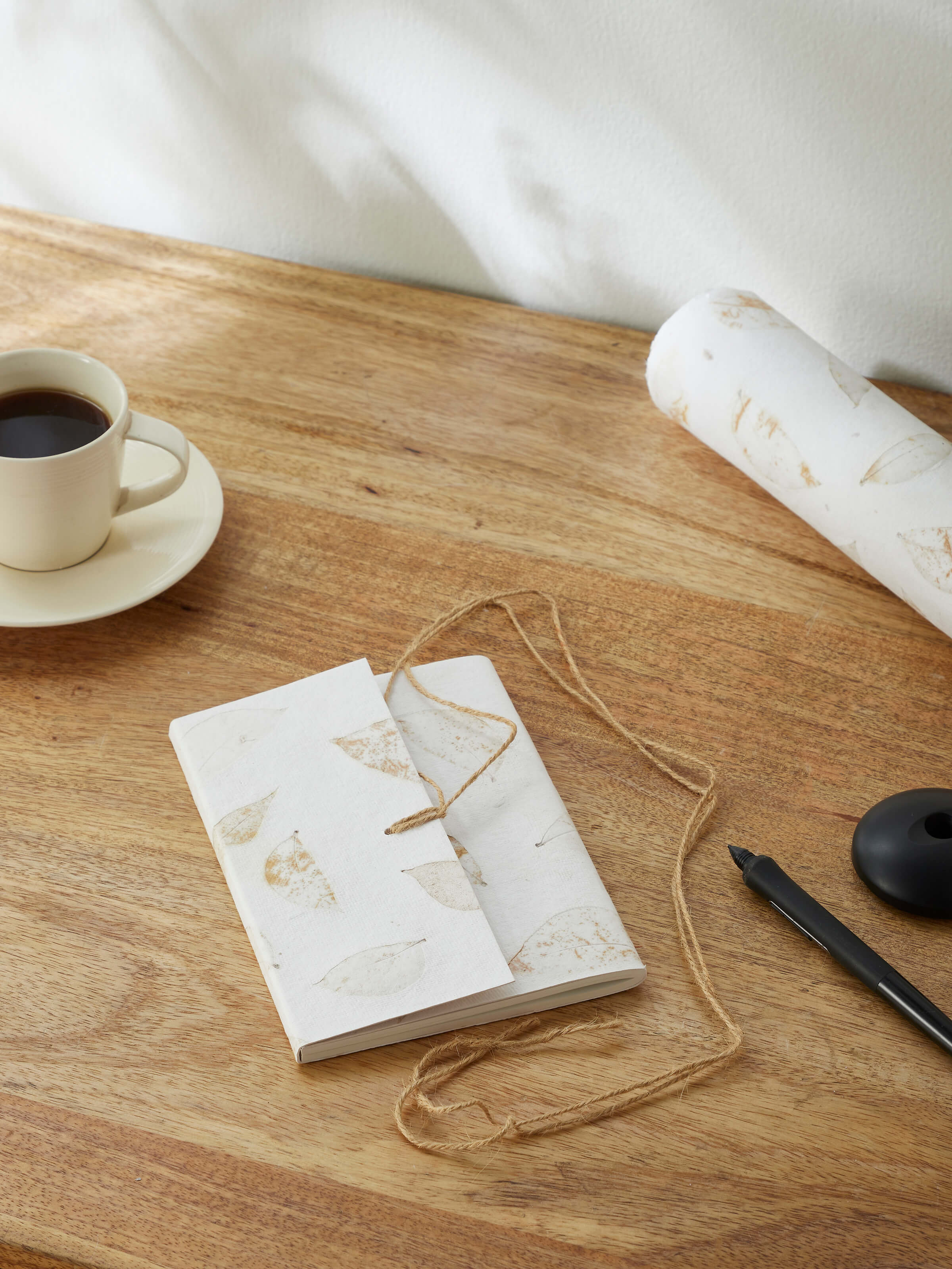 Side view of Auroville Handmade Paper Notebook with Rope in white, showing the binding and cover details.