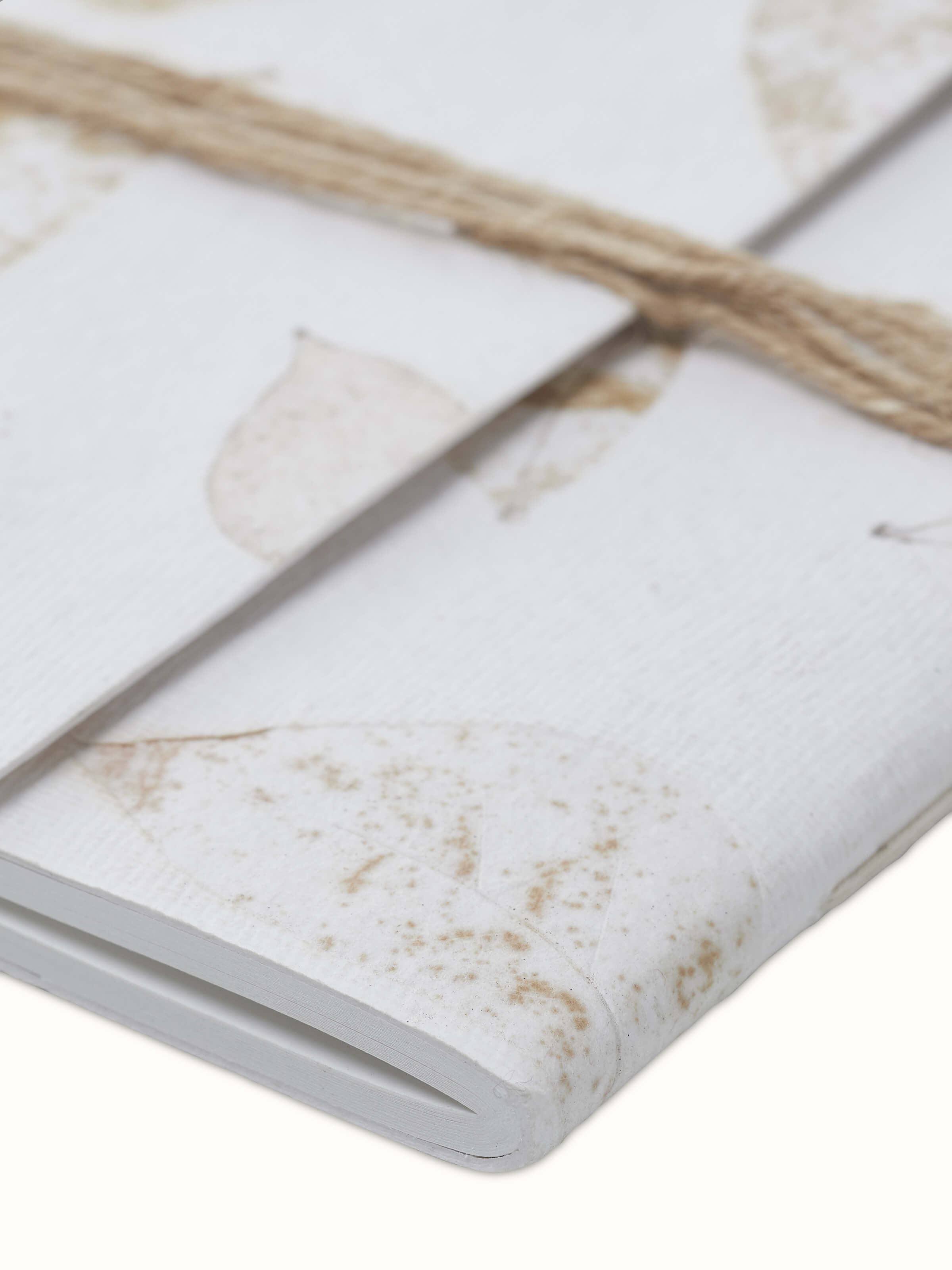 Close-up detail of Auroville Handmade Paper Notebook with Rope in white, focusing on the handmade paper texture and binding.