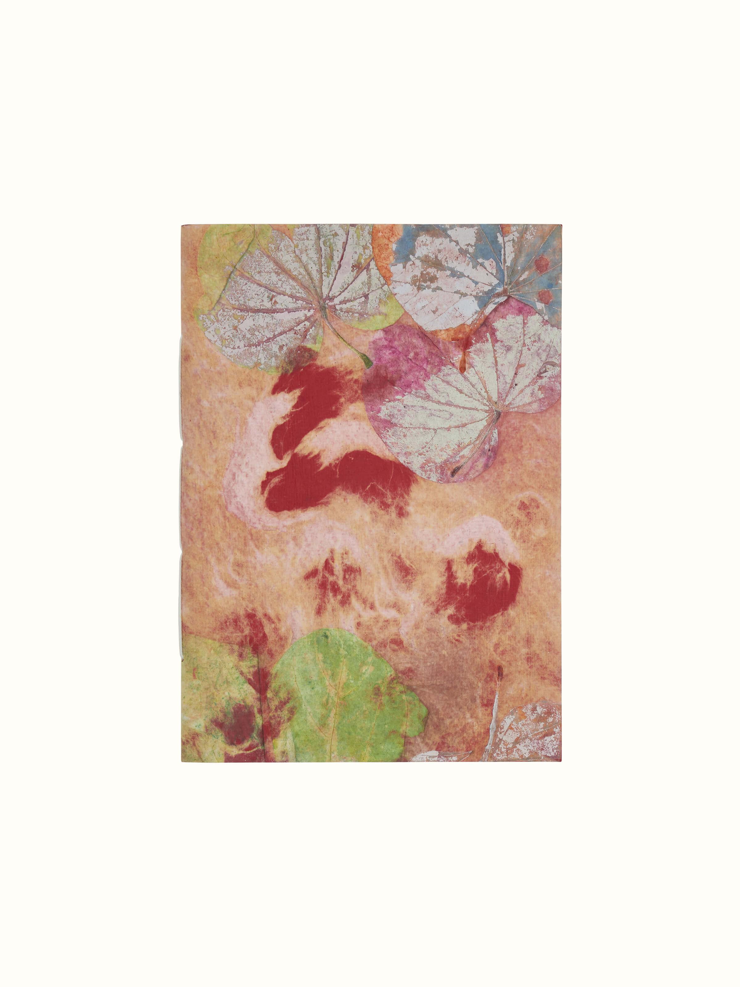 Top view of Auroville handmade paper notebook in orange showcasing its detailed paper texture and binding.