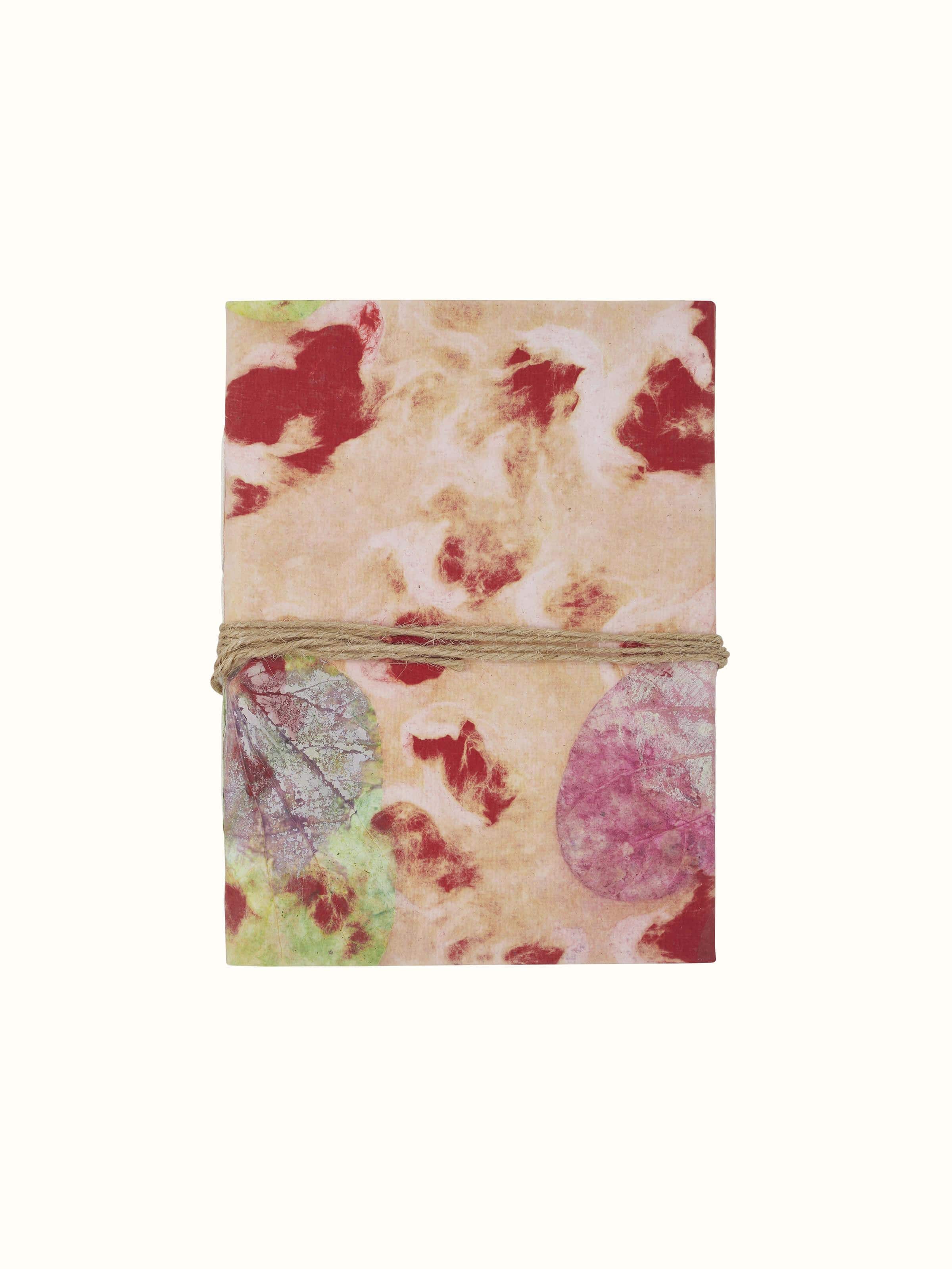 Front view of Auroville Handmade Paper Notebook in pink, featuring a textured cover and elegant design