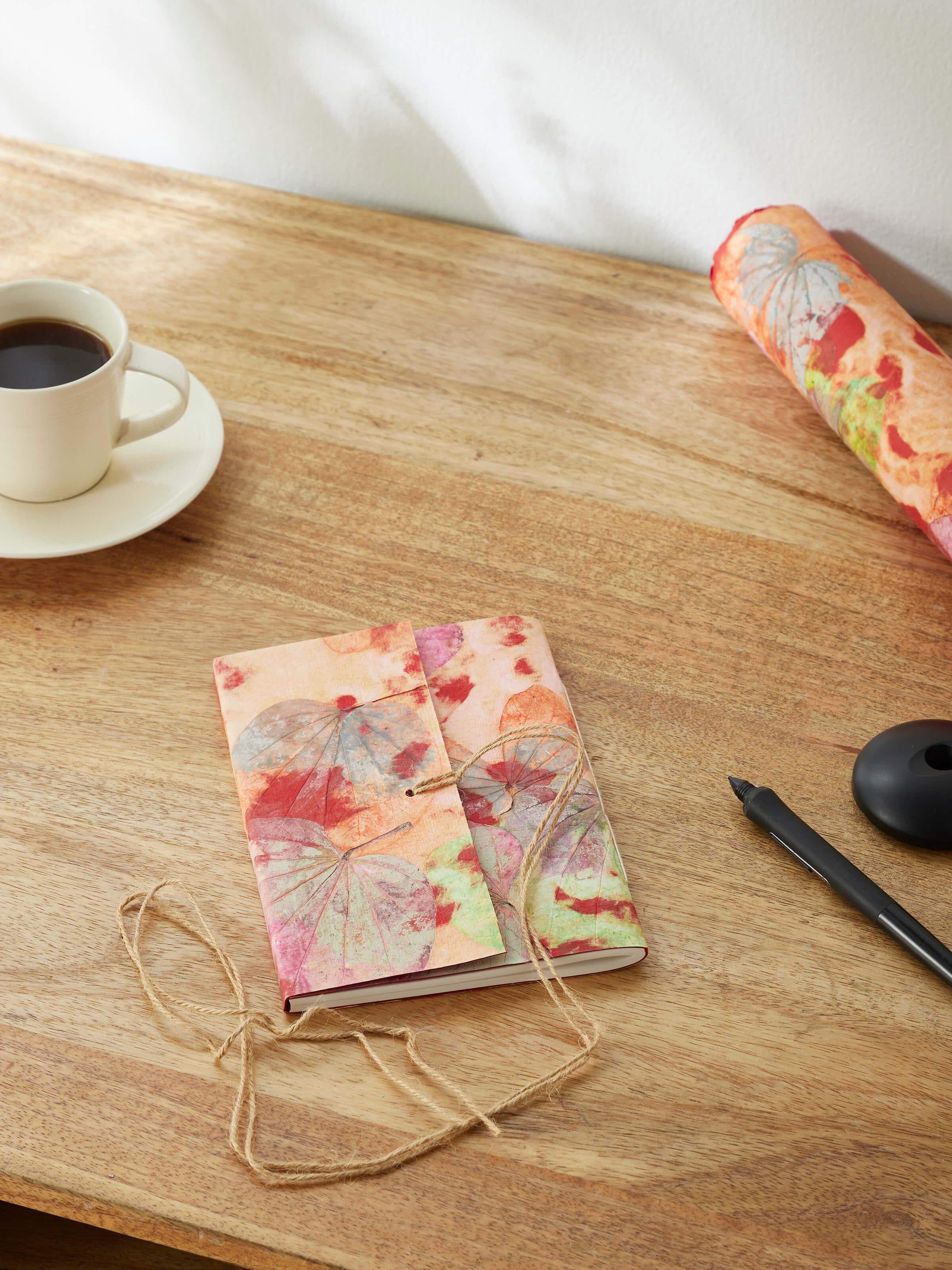 Close-up of Auroville Handmade Paper Notebook pink cover, highlighting the texture and craftsmanship