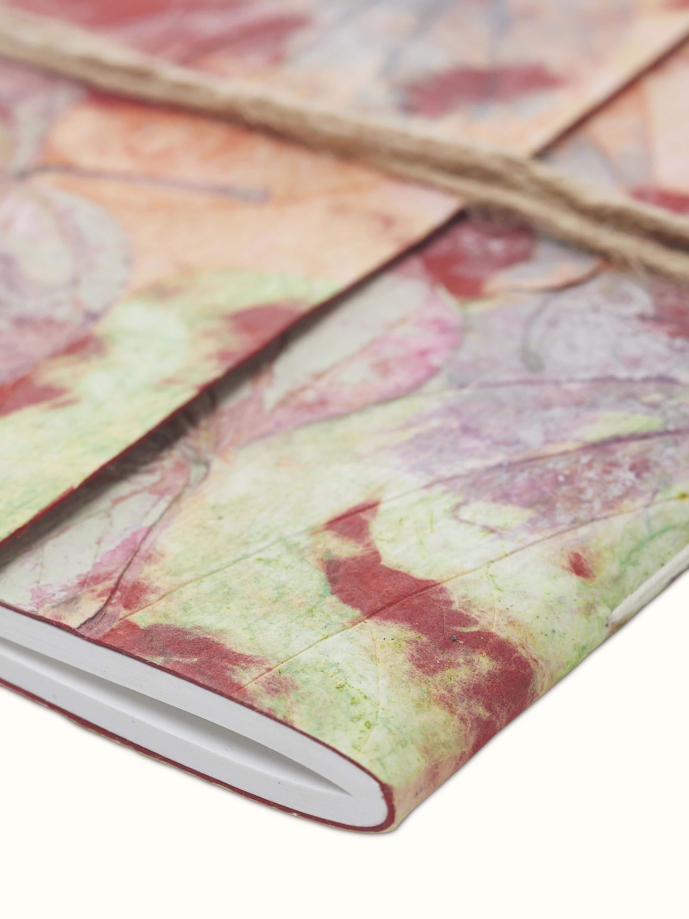 Side view of Auroville Handmade Paper Notebook pink, showing the thickness and quality of handmade paper