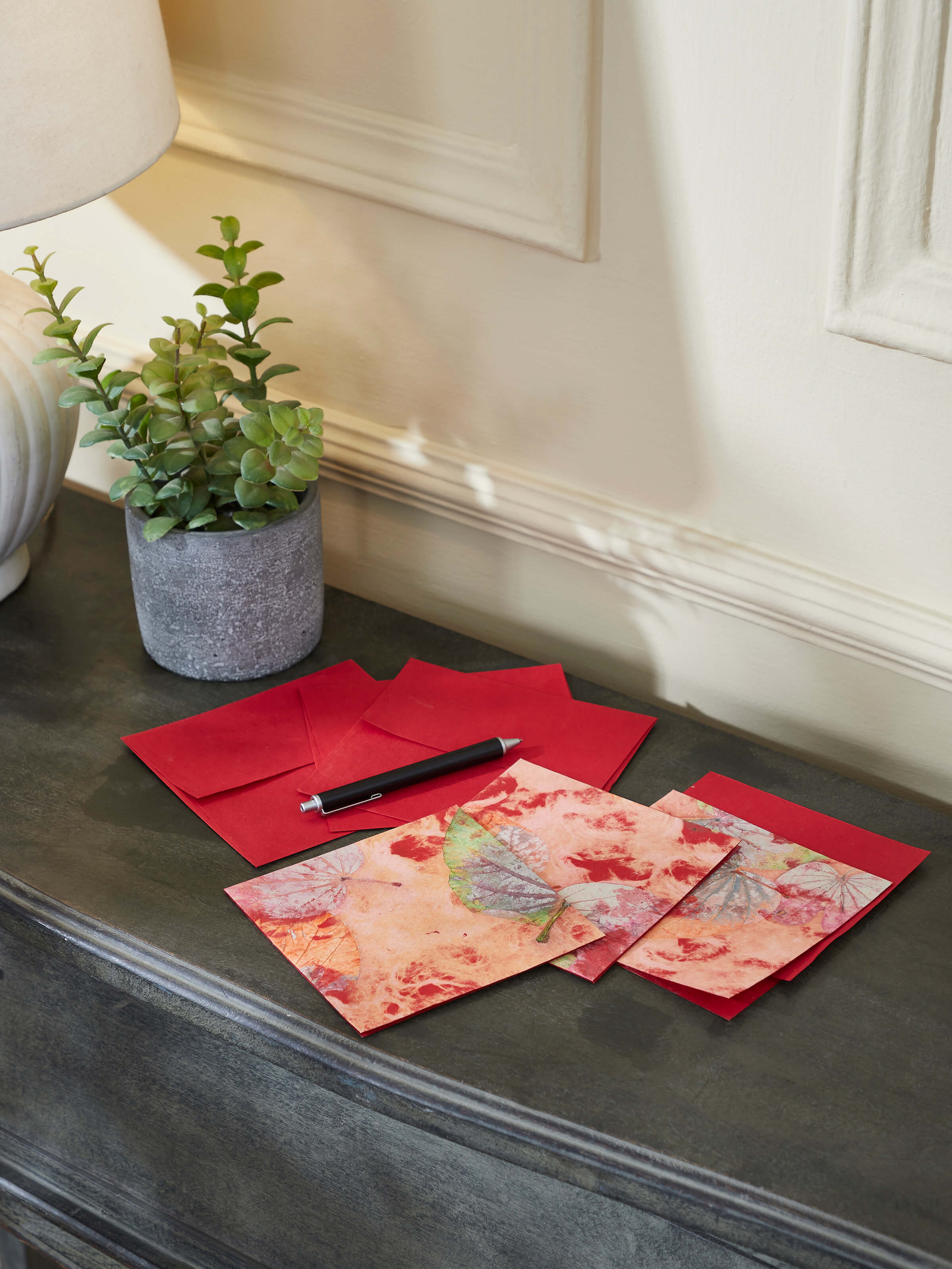 Side view of Auroville Handmade Paper Money Envelopes in red, highlighting the texture and design of the envelopes